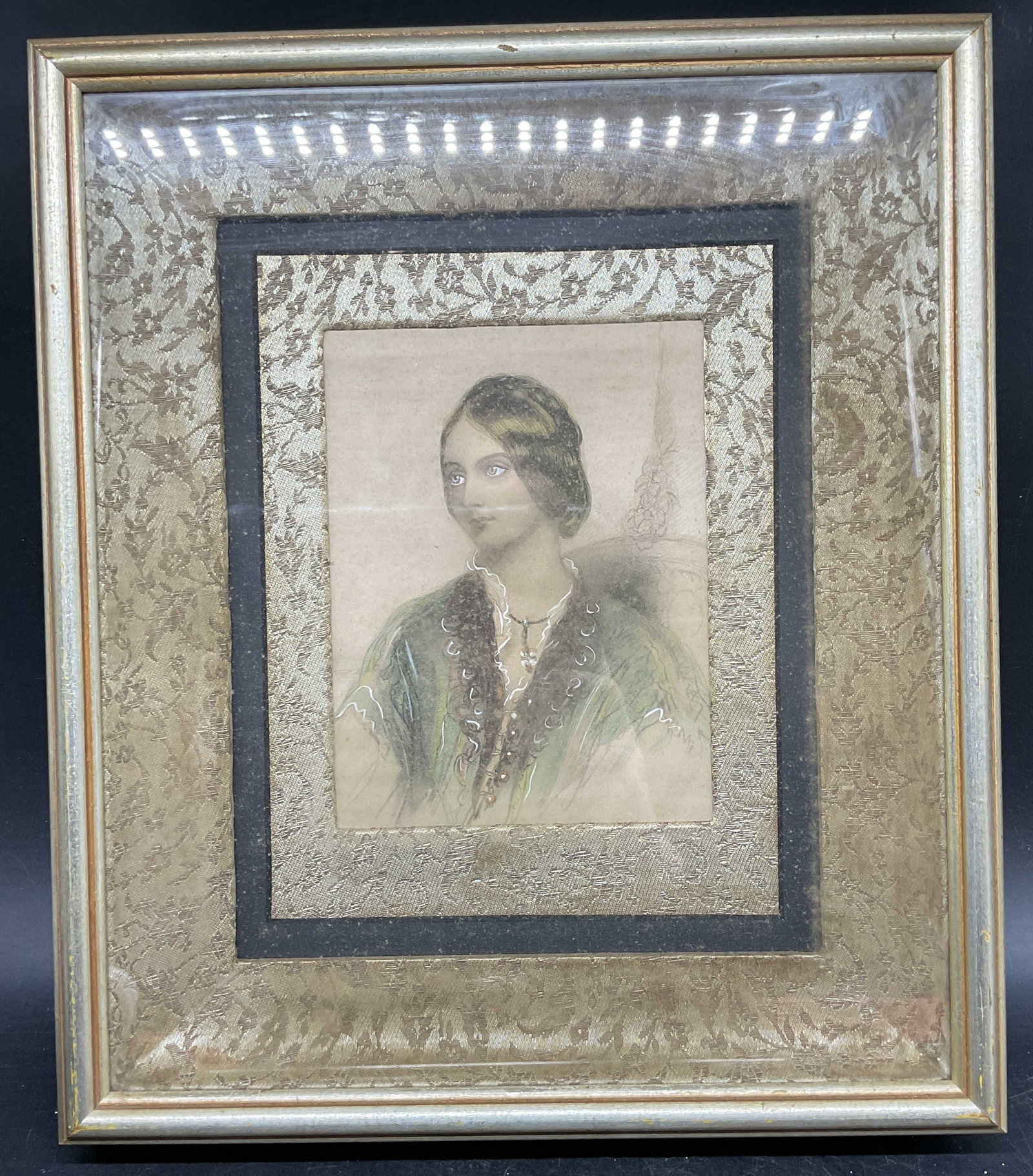 Antique Portrait Hand Colored Stipple Engraving: Framed and matted Antique hand colored stipple engraving. Portrait of a woman. Label on verso, Sungott Art Studios. Gilt wood framed with decorative mat. Frame measures approx. 14 x 12 inches. Not exa