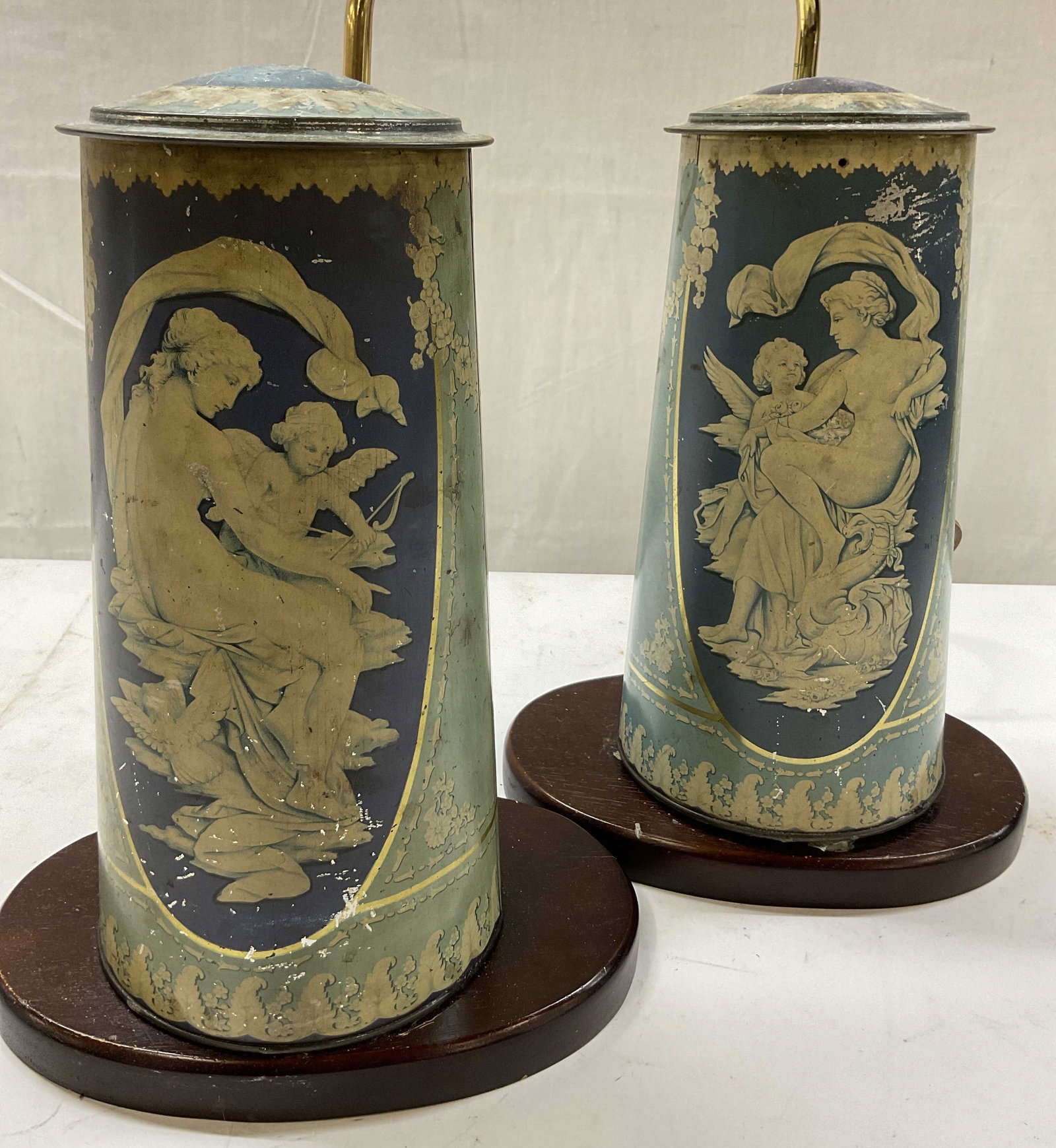 Pr Antique Toleware Canisters Into Lamps: Pair of 19th century hand painted toleware canisters , possibly European, made into lamps, mounted on wood bases with brass arms, each canisters painted with neoclassical figurals of maiden with an an