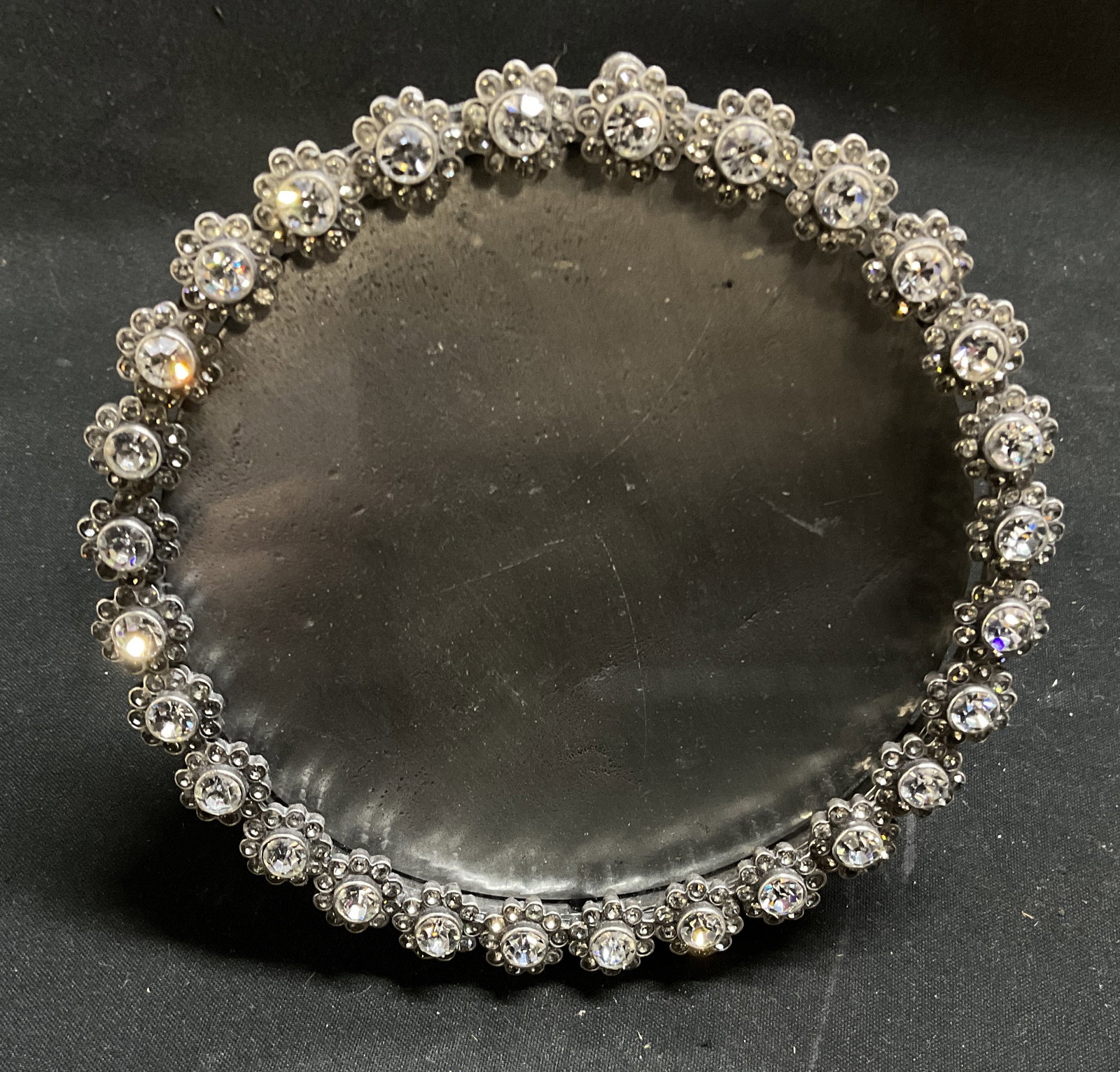 Jay Strongwater Swarovski Crystal Picture Frame: Jay Strongwater Swarovski Crystal Embedded Circular Picture Frame. Floral Design. Silver-Toned Metal Frame. Swirled Grey Enamel at the Back. Condition Consistent With Exposure. Measures app 4.5in H x 