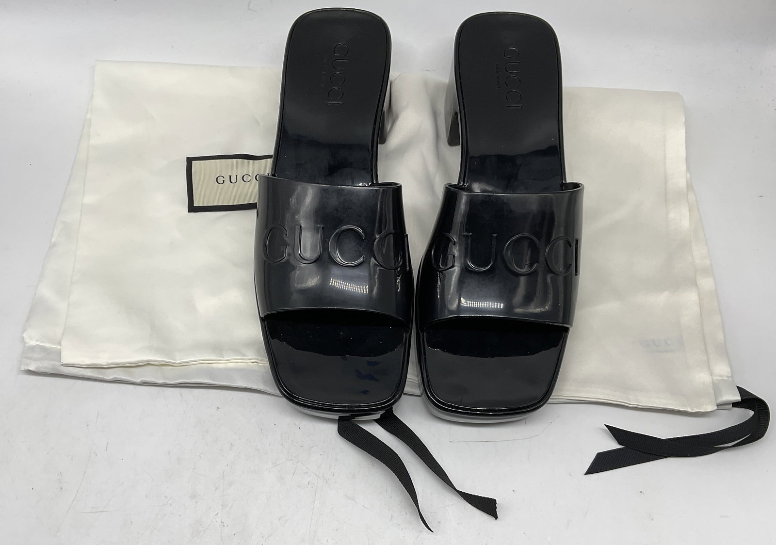 Pair GUCCI Womens Slide Sandals ITALY: Pair of Gucci Womens Glossy Rubber Slide Sandals. Embossed Gucci Logo. Never Worn. Made in Italy. EU Size 37 (U.S. 7). Comes with White Silk Storage Bags. Gucci, Gucci Shoes, Luxury, Designer, Rubber 