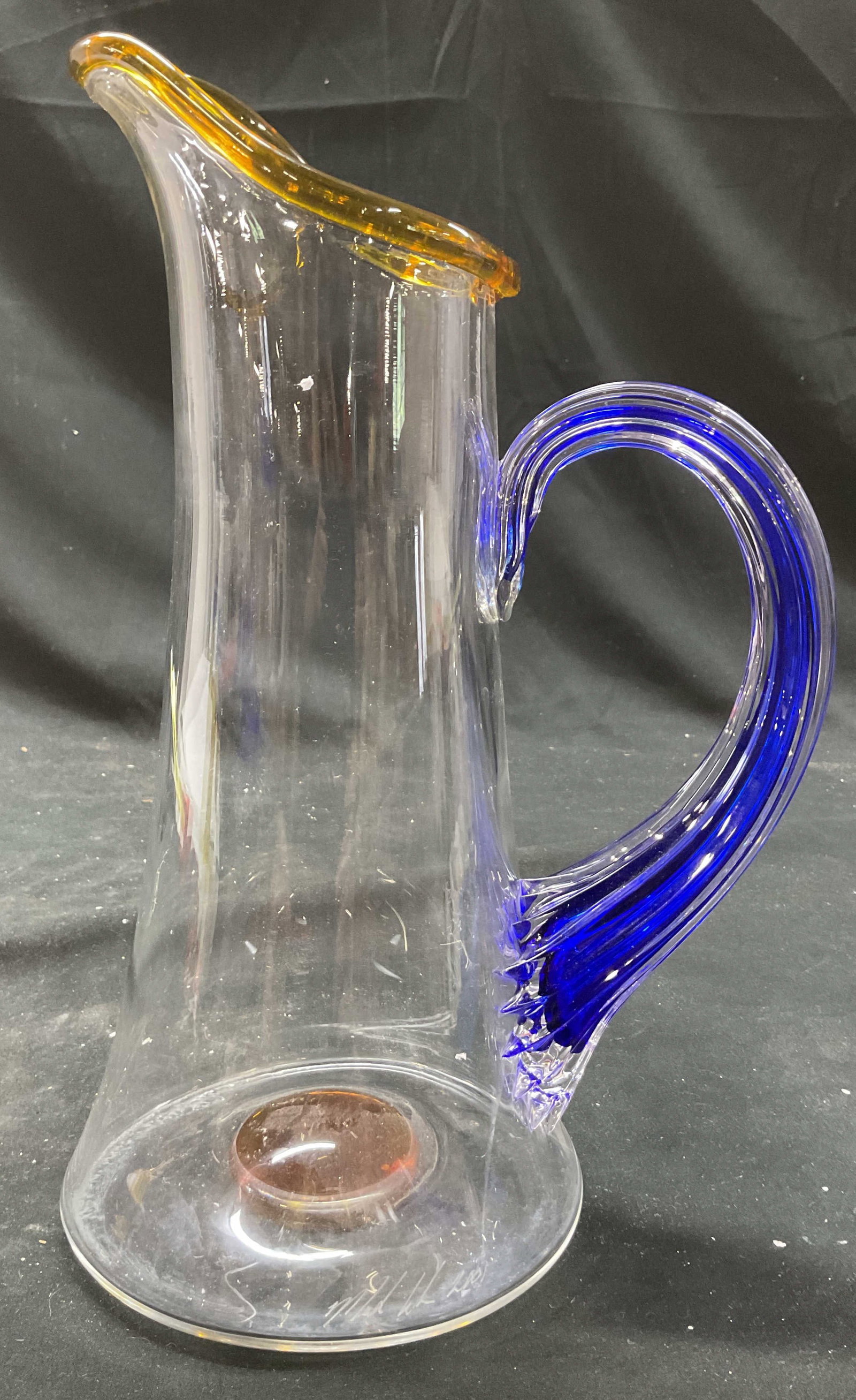 Marthas Vineyard Blown Glass Pitcher: Marked on underside for Marthas Vineyard and additional writing illegible, tall pitcher with ribbed cobalt blue glass arm and amber toned rim, measures ht 13 inches, handle to spout app 9 inches,