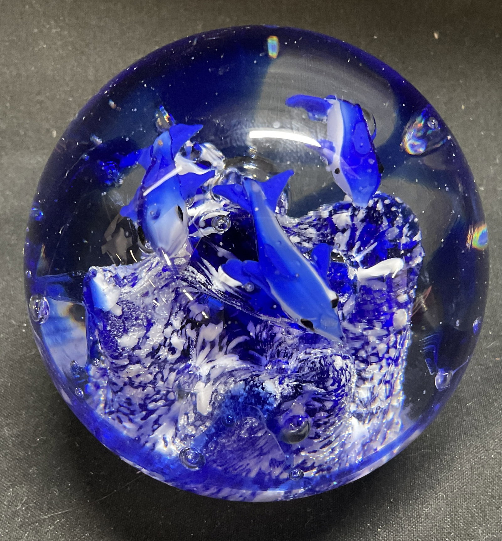 VTG Hand-Blown Glass Dolphin Paperweight: Vintage Hand-Blown Glass Dolphin Paperweight. Blue and White Core with Controlled Bubbles and Swimming Dolphins. Condition Consistent With Exposure. Measures app 3.25in H x 3in Diam. Vintage Paperweig