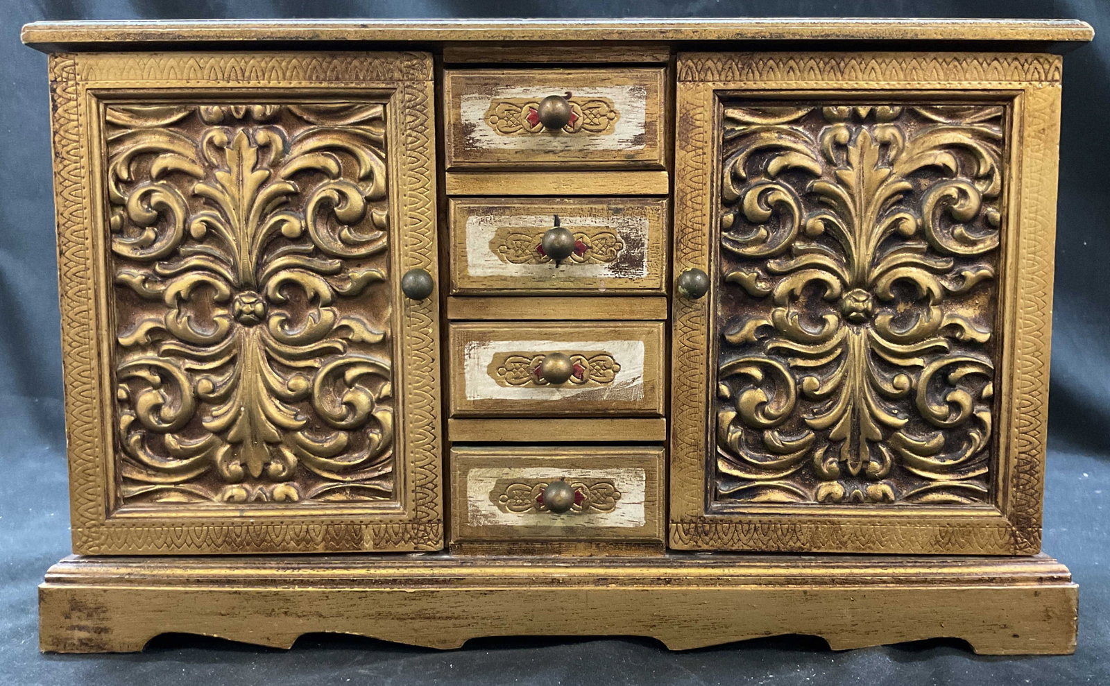 Giltwood Florentine Style Jewelry Music: Giltwood Florentine style jewelry box, two scroll work doors flanked by center drawers, doors open to reveal additional drawers which are felt lined, made in Japan , music box, measures ht 10 inches,