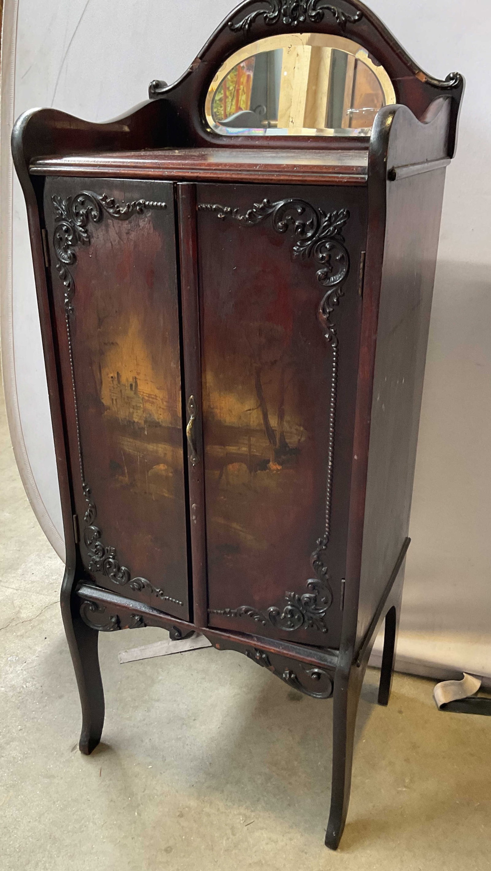 Antq Victorian Music Storage Cabinet: Antique 19th century Victorian style sheet music storage cabinet, features hand painted scenes on two front cabinet doors, carved top with inset mirror, the interior has pull out sheet music storage s