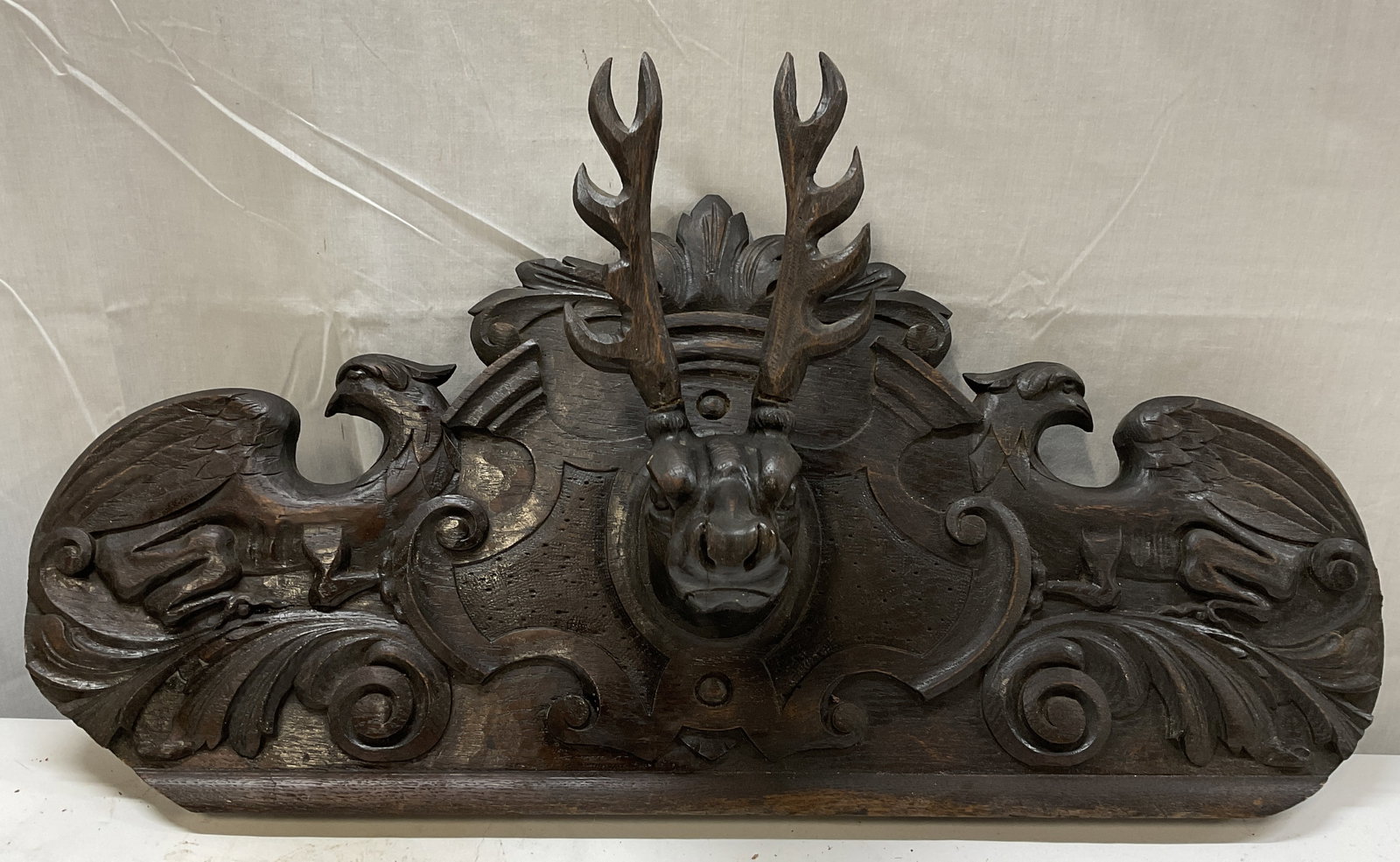 ANTQ Neo-Renaiss Sty Wooden Stag&Griffins Plaque: Antique Neo-Renaissance Style Dark Stained Carved Wooden Plaque. Features a Central High-Relief Stag Head Surrounded by Griffins and Acanthus Leaf Motifs. Finish Wear Present. Measures app 16in H x 29