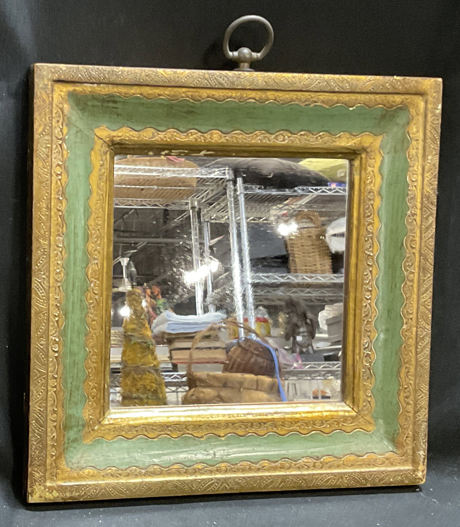 VTG Florentine-Sty Green&Gilt Framed Mirror ITALY: Vintage Florentine-Style Green and Gilt Framed Square Mirror. Engraved Floral Patterns. Made in Italy. Some Cracks and Scuffing. Measures app 11in H x 9.5in L x 9.5in W. Vintage Mirror, Florentine-Sty