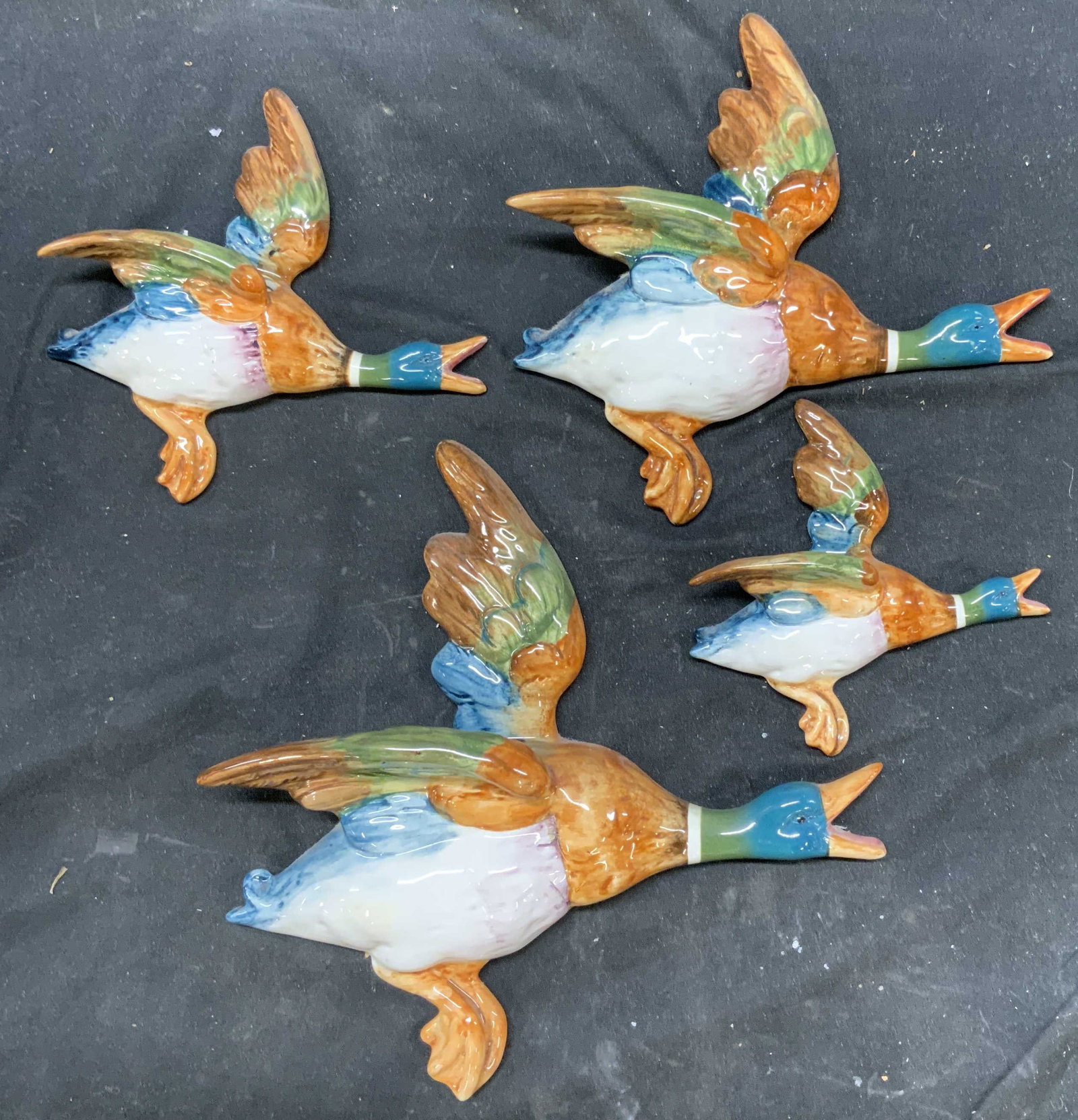 Set 4 Beswick Flying Mallard Plaques, England: Set of four flying Mallards, glazed ceramic Porcelain., Beswick ducks, England, all four ducks have mounts for wall display, this is a graduated set of four, largest measures app 11 inches ht, length 