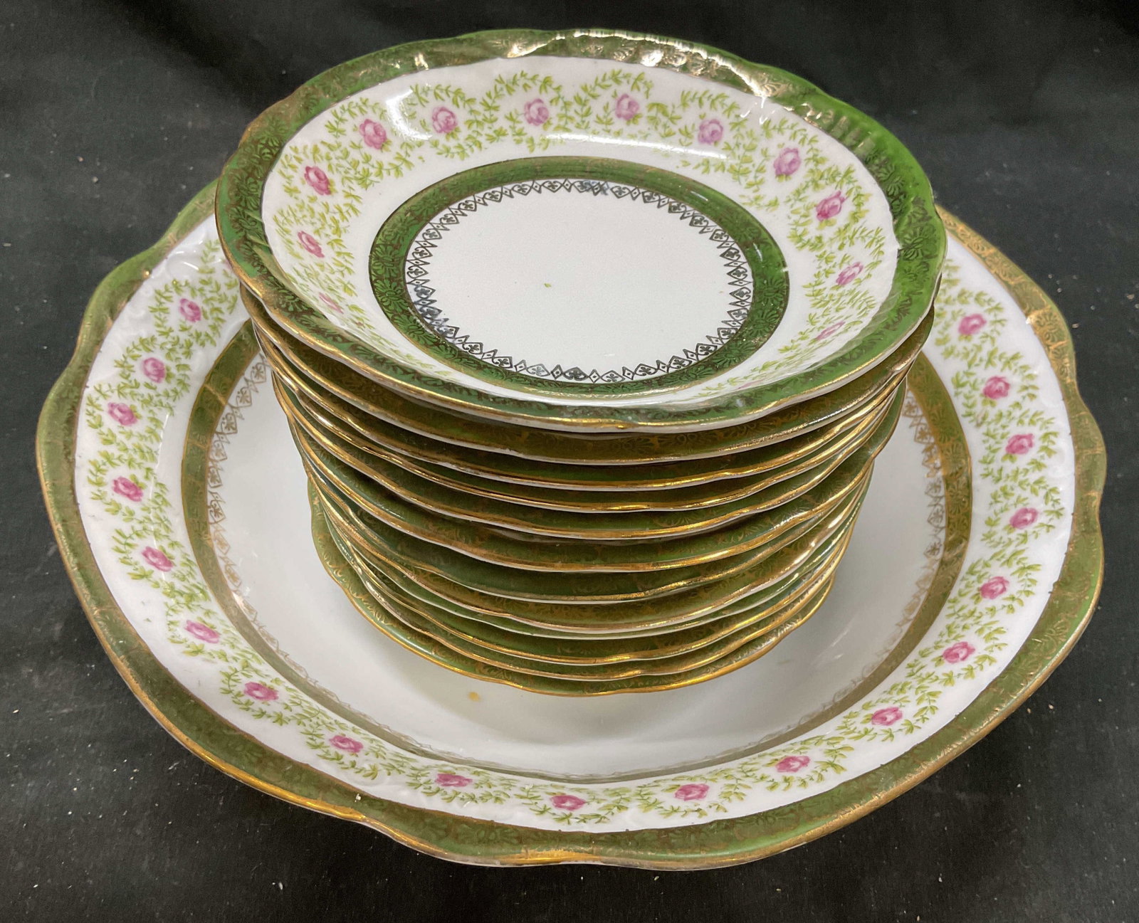 Set Altrohl Austria Antq Serve Bowl w 12 bowls: Antique set Altrohl Austria Porcelain serving bowl diameter 10 inches ht 3 inches, with 12 shallow bowls diameter 6 inches, delicate green and gold border, band of pink roses and lime green leaf rings