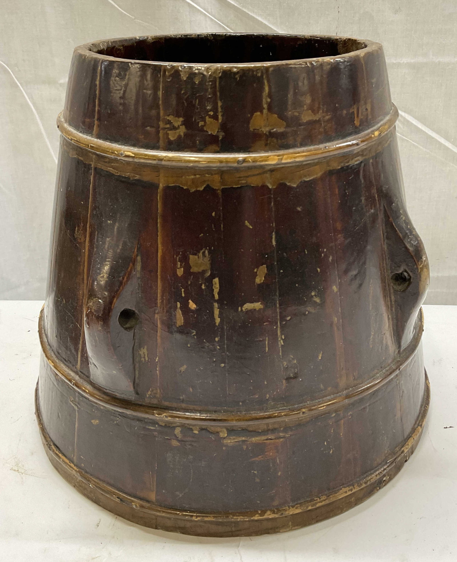 ANTQ 19th-20th C Chinese Grain Holder Bucket: Antique Circa 19th-20th Century Chinese Grain Holder Bucket. Lacquer Coated Dark Wood with Carved Ridges and Bands. Lacquer Loss and Chips Present. Measures app 11.25in H x 11in Diam. Antique Buckets,