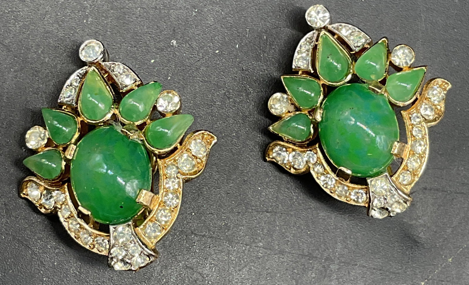 Vintage Trifari Jewels of India Earrings: Vintage Trifari Jewels of India collection gold tone rhinestone and green lucite earrings. Measures approx. 1.25 x 1 inches. Some scratching. Jewelry, estate jewelry, costume jewelry, cocktail jewelry