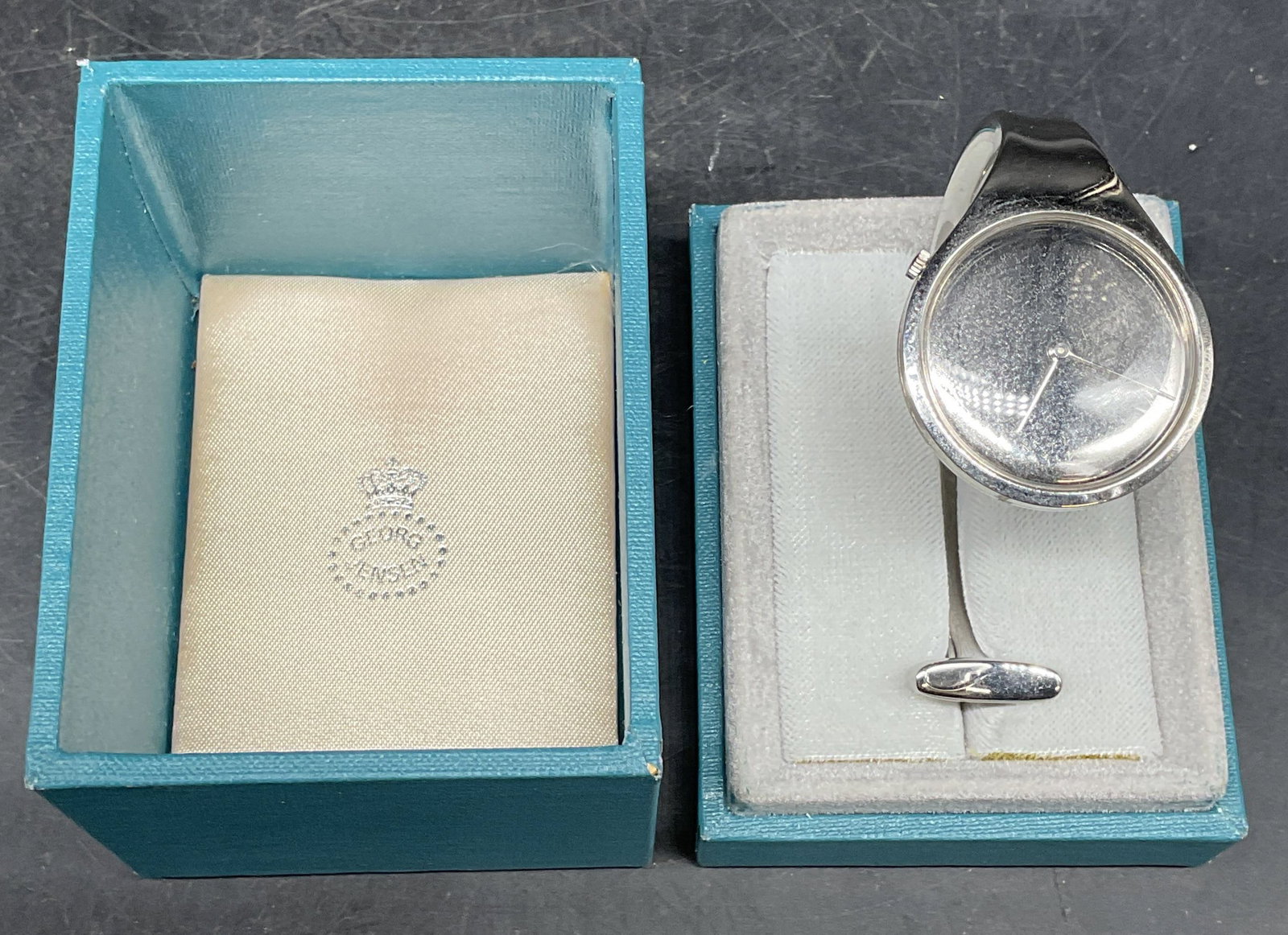 Georg Jensen Torun Stainless Steel Bangle Watch: Georg Jensen stainless steel bangle watch. Designed by Vivianna Torun. Made in Denmark. Numbered 8005 1 62845. Measures approx. 2.5 inches wide. Includes Georg Jensen box. Not tested, wear including p