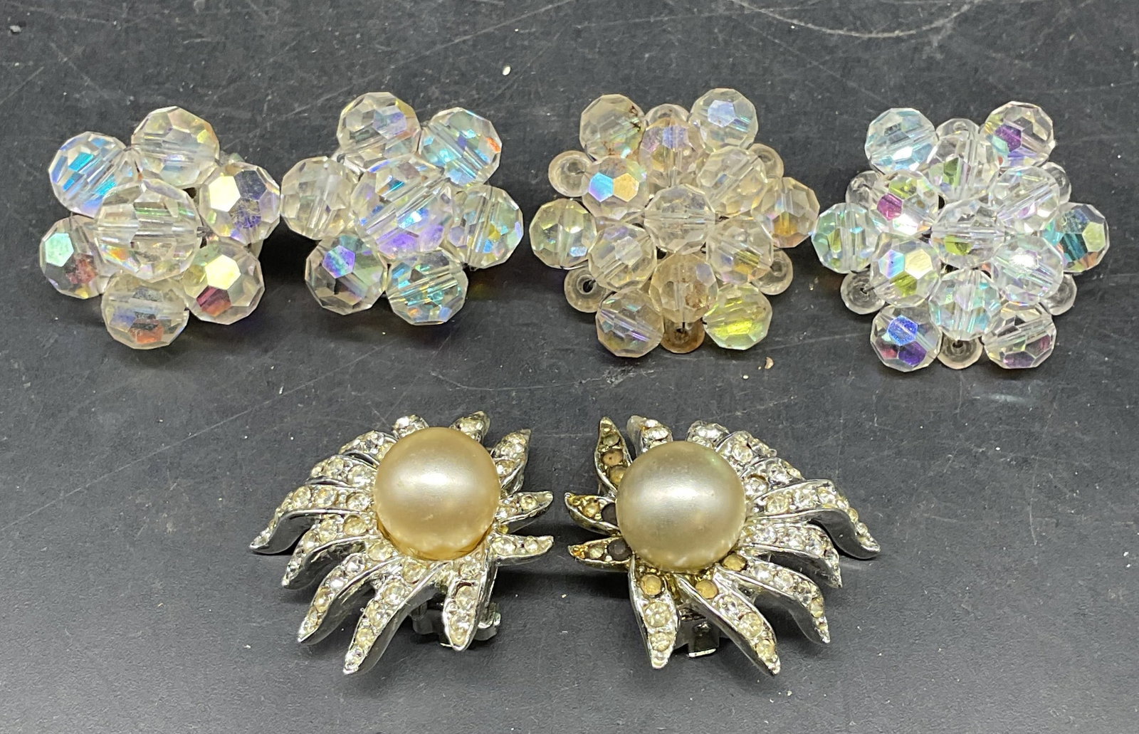 Lot 3 Vintage Faux Pearl & Lucite Earrings: Lot of 3 pairs of vintage earrings. Two pairs of colorless lucite beaded earrings and pair of silver tone rhinestone and faux pearl earrings. Largest measures approx. 1.25 inches wide. Some scratching