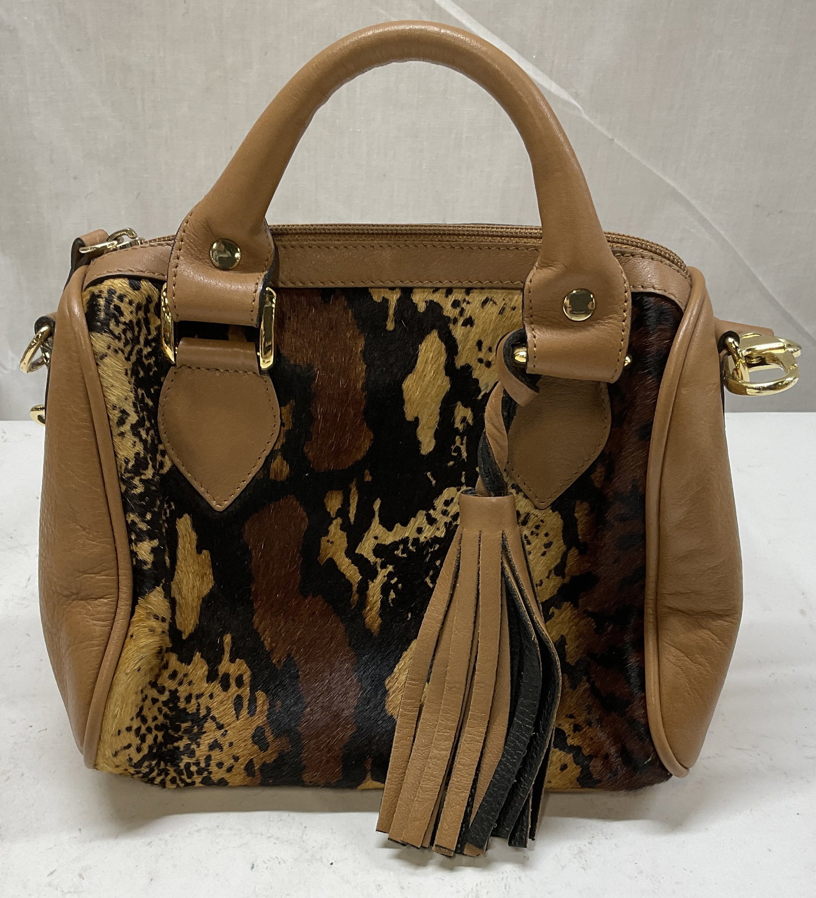 Clever Carriage Company Pony Hair Satchel: Clever Carriage Company Pony Hair and Leather Satchel. Animal Print Design. Condition Consistent With Exposure. Measures app 7in H x 8.5in L x 4in W. Clever Carriage Company, Pony Hair, Calf Hair, Ani