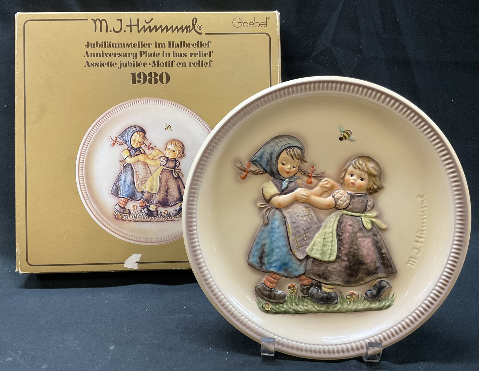 1980 Goebel Anniversary Plate Germany W Box: 1980 Goebel porcelain anniversary plate. Comes in original box. Marked on underside as photographed here. Made in Germany. Titled Spring Dance. Signed. Two child figures dancing, in varying colors, ha