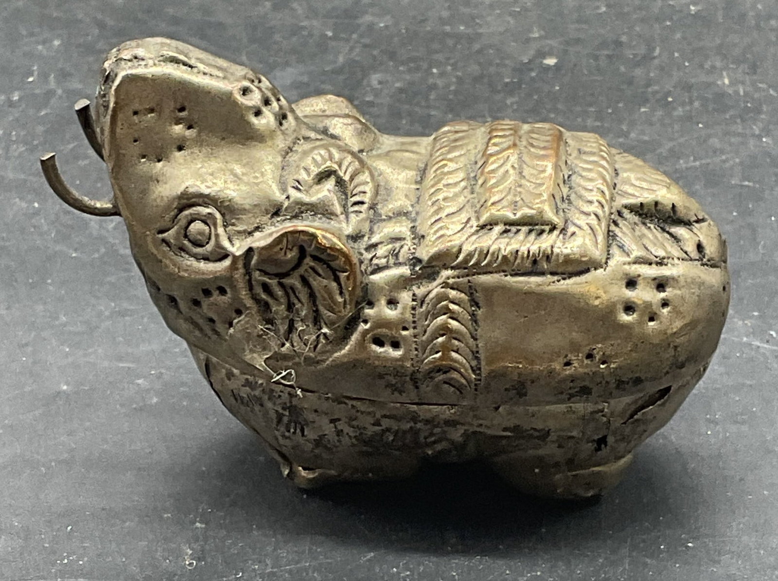 Silver Tone Elephant Repousse Trinket Box: Silver tone elephant motif repousse trinket box. Measures approx. 2.5 x 1.25 x 1.75 inches. Scratching, patina, and warping. Elephant trinket box, trinket box, home decor, table decor, 10 s
