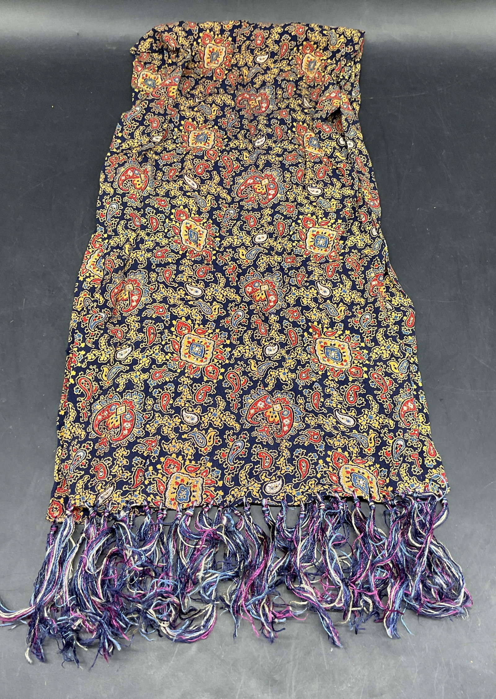 Vintage Blue Red Paisley Fringe Scarf: Vintage blue, red, and yellow paisley pattern fringe scarf. Synthetic material. Measures approx. 36 inches long. Some blemishes. Paisley scarf, blue scarf, red scarf, yellow scarf, vintage scarf,