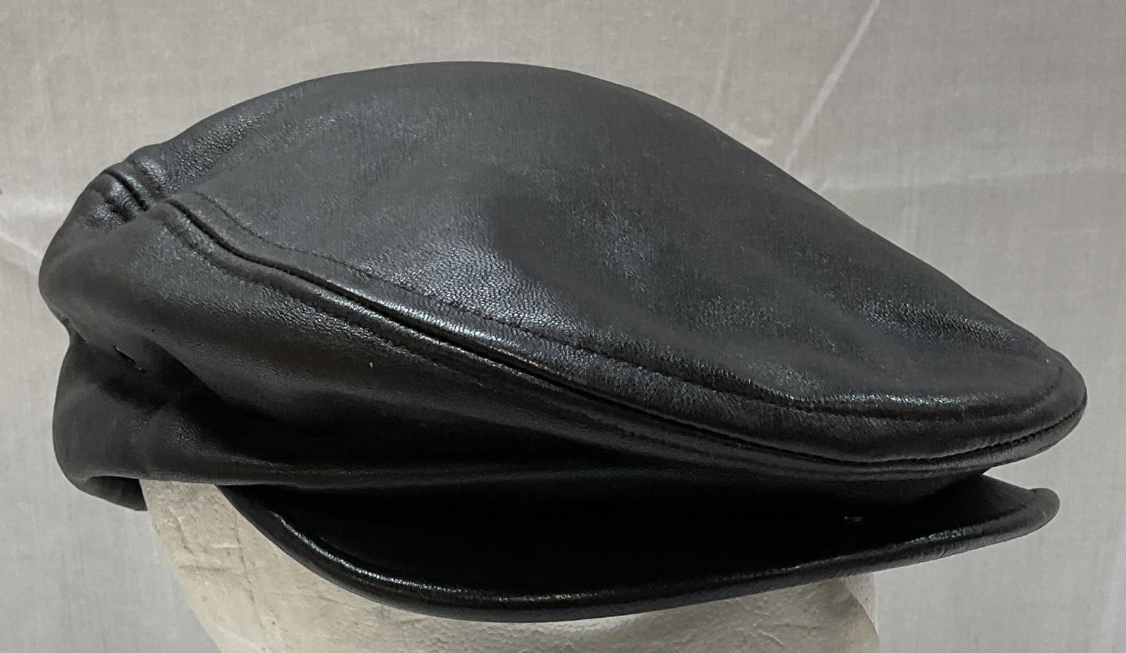DKNY Black Leather Scally Cap: DKNY black leather scally cap. Measures approx. 7.5 inches wide. Some scratching and rubbing. DKNY hat, leather hat, black hat, accessories, fashion accessories, designer hat, 10 cs
