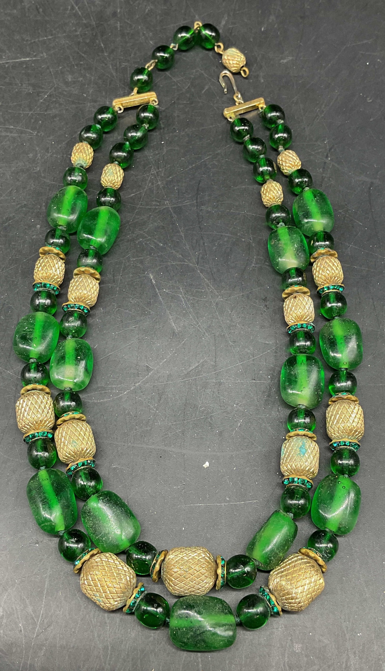 Vintage Gold Tone Green Glass Necklace: Vintage gold tone and green glass beaded double strand necklace. Drop length 6.5 inches. Some scratching. Jewelry, estate jewelry, costume jewelry, cocktail jewelry, fashion jewelry, accessories, fash