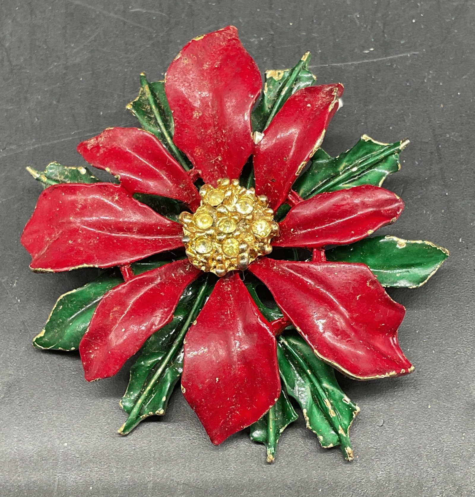 ART Gold Tone Enamel Poinsettia Brooch: Vintage ART Arthur Pepper gold tone enamel and rhinestone poinsettia brooch. Measures approx. 2 inches wide. Some scratching. Jewelry, estate jewelry, costume jewelry, cocktail jewelry, fashion jewelr