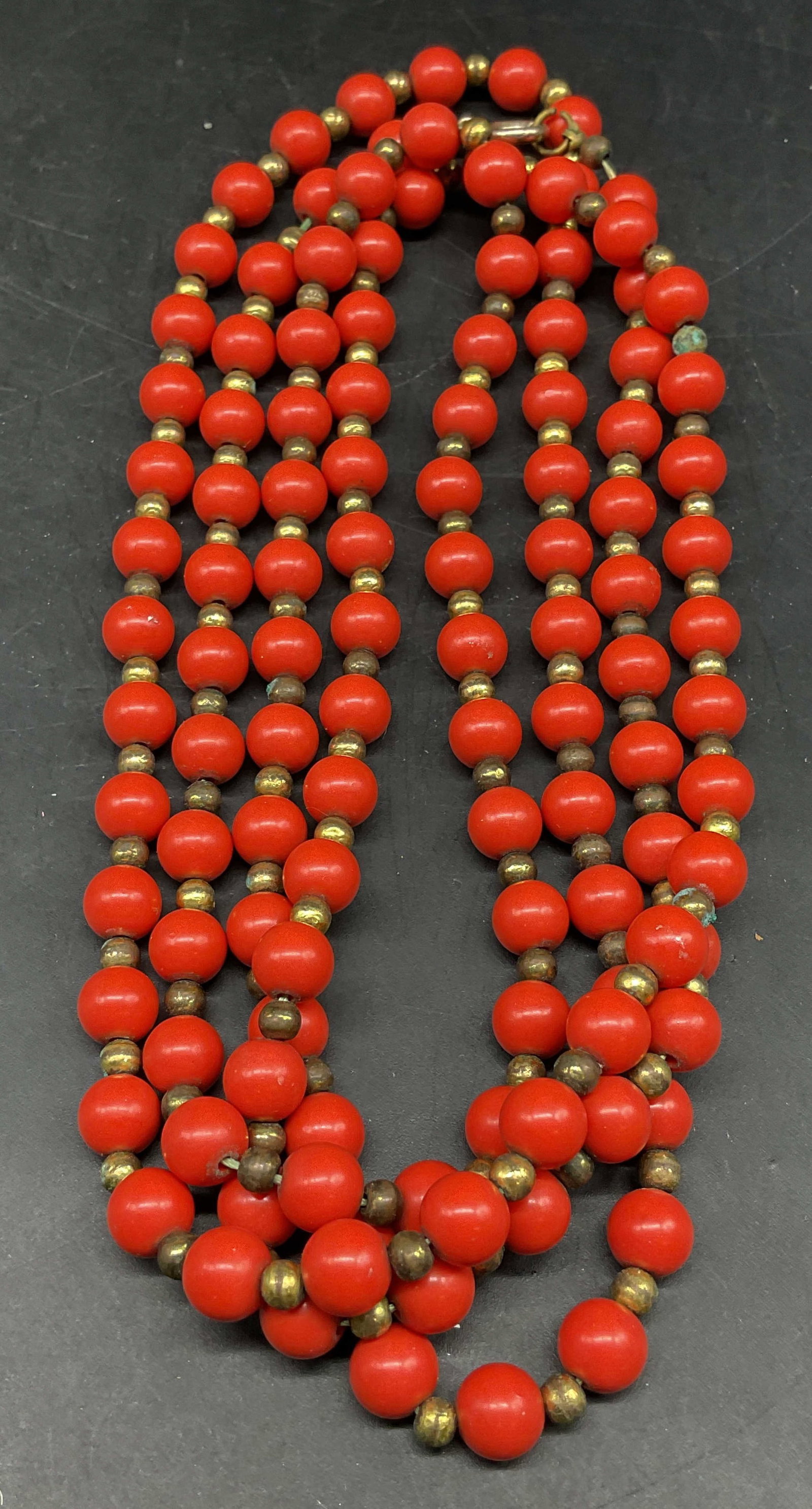 Vintage Gold Tone Red Beaded Necklace: Vintage gold tone and red beaded necklace. Drop length 26 inches. Some scratching. Jewelry, estate jewelry, costume jewelry, cocktail jewelry, fashion jewelry, accessories, fashion accessories, 10 j
