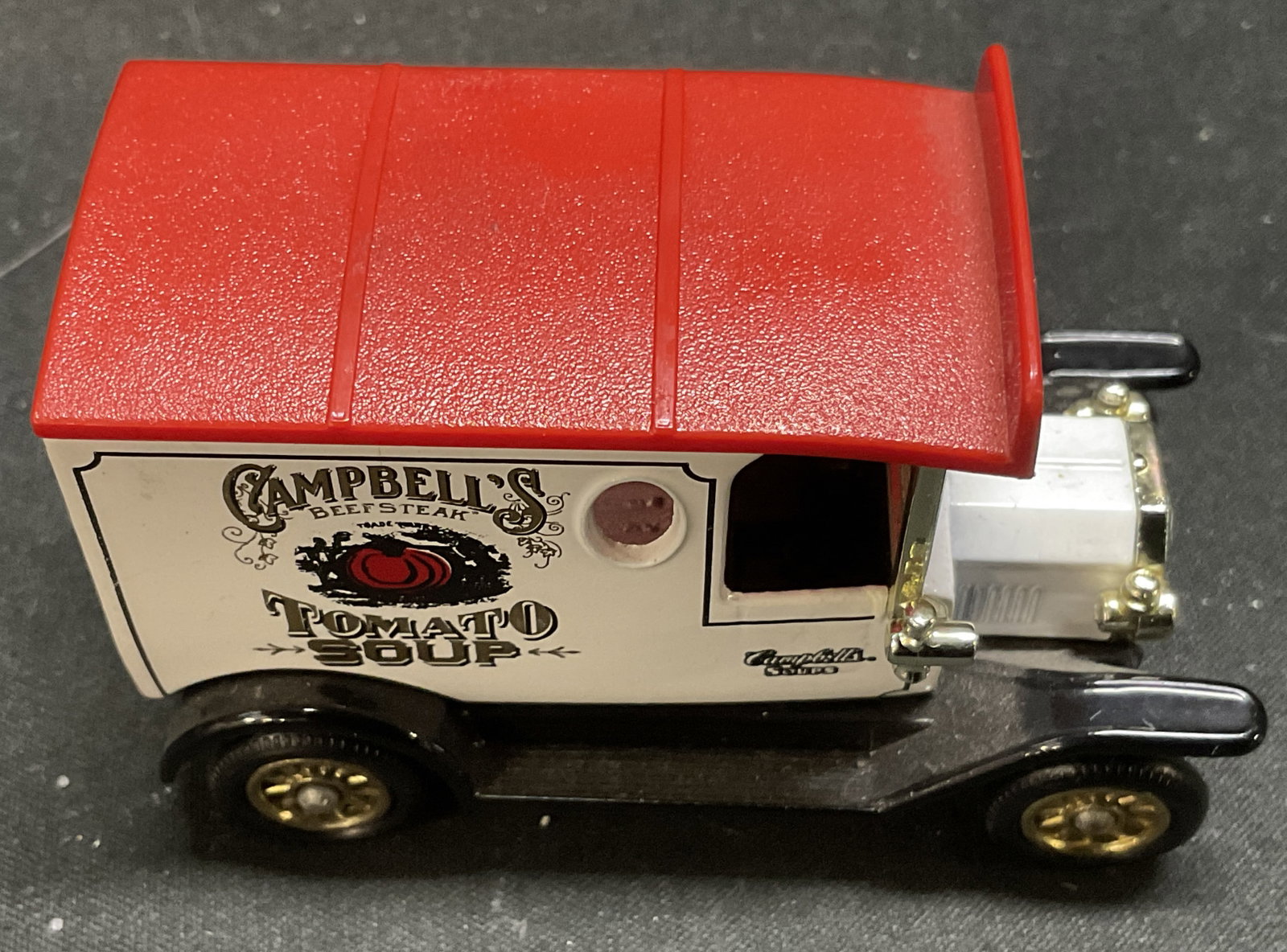 1997 Lledo Campbells Soup Truck Model ENGLD: Vintage 1997 Lledo Days Gone 20s-30s Era Campbells Tomato Soup Delivery Truck Diecast Model. Black and White with Red Roof and Tomato Logo. Gold-Toned Accents. Made in Enfield, England. Condition Cons