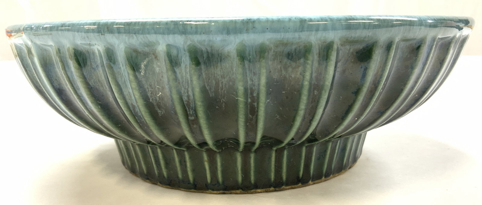 Vtg 1960s Hull pottery bowl made in USA: Vtg 1960s Hull pottery bowl, high-gloss green, blue drip edge glaze, made in USA, bottom clearly marked, Hull USA A-12, surface wear consistent with age and use, small rim chip, ribbed exterior, 9.5in