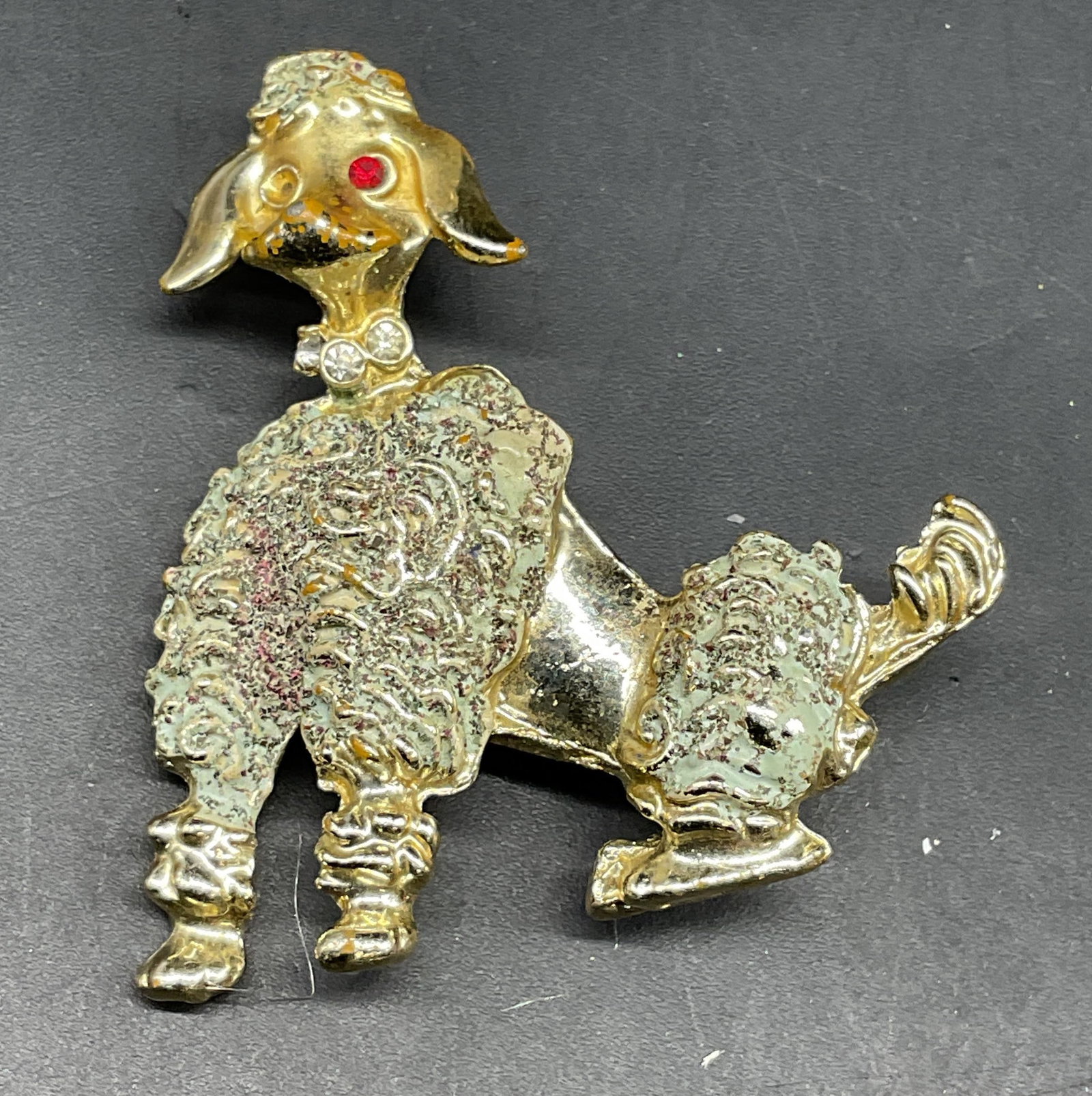 Vintage Gold Tone Enamel Poodle Brooch: Vintage gold tone enamel poodle brooch. Measures approx. 1.75 x 1.5 inches. One rhinestone needs replacement. Some scratching. Jewelry, estate jewelry, costume jewelry, cocktail jewelry, fashion jewel
