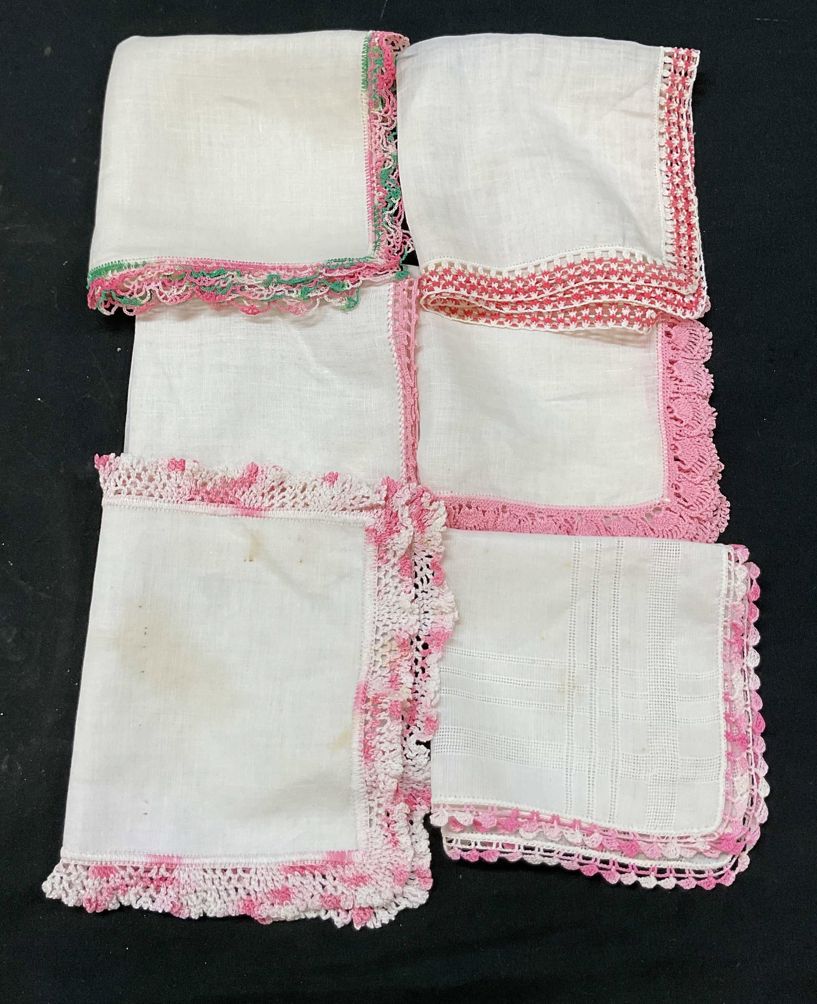 Grp Lot 6 Vtg White & Pink Crochet Table Linens: Group lot of 6 vintage white and pink crochet table linens. Napkins and placemats. Crochet design trim in pink, white, and green. Size, shape, design vary. Largest measures approx 11 x 11 inches. Blem