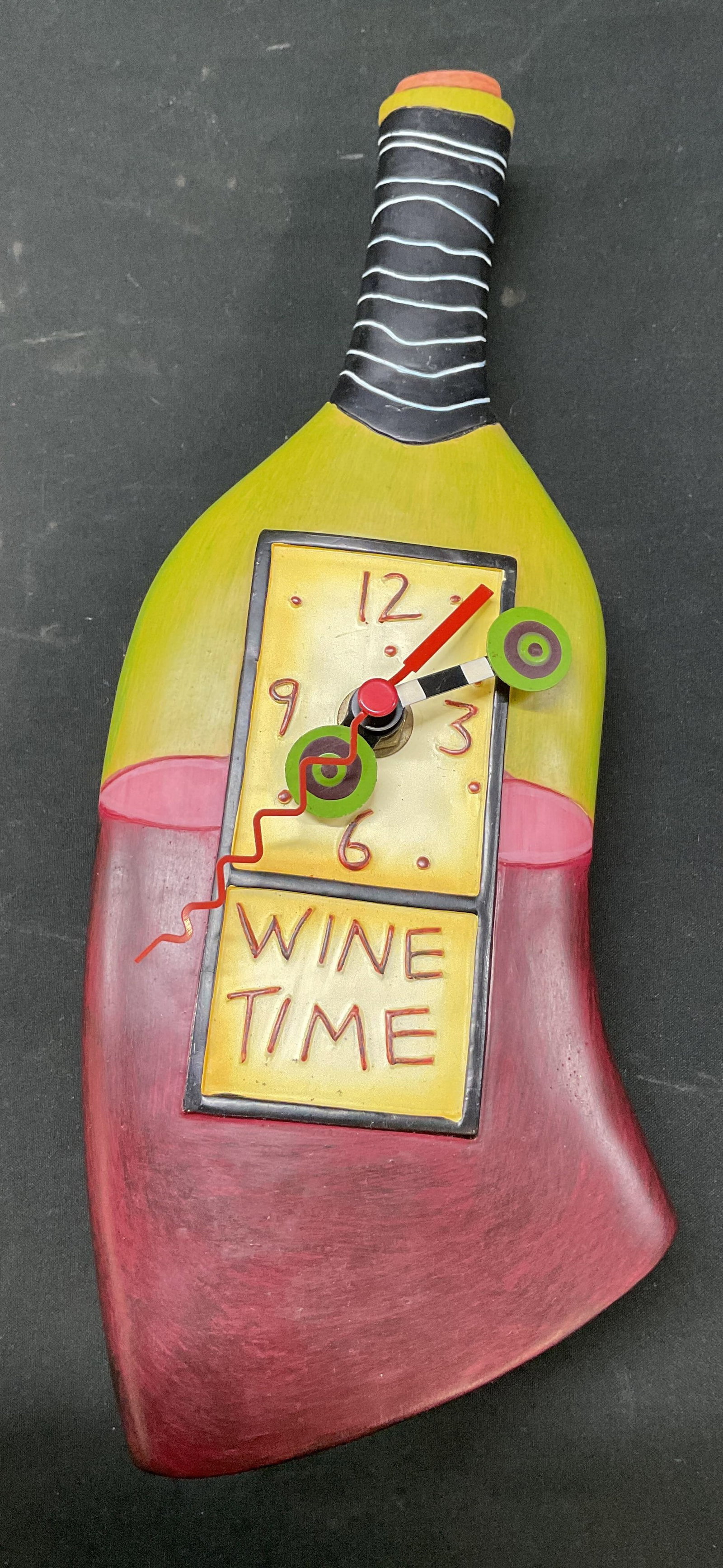 Allen Designs Wine Time Wall Clock: Allen Designs resin hand painted Wine Time wall clock. Marked on backside, reads Allen Designs Studio Collection. Wine bottle shape. Face reads Wine Time. Hand painted in varying colors. Detailed feat