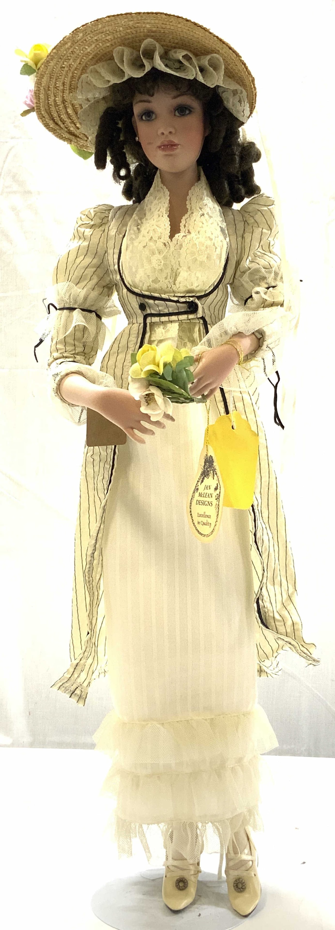 VTG Jan McLean Marianne Porcelain Doll New Zealand: 1999 VTG Jan McLean Marianne 26in porcelain doll, New Zealand, hand painted features, brown curly hair, blue eyes, costume of quality fabrics and laces sourced all over the world, signed and dated on 