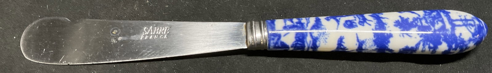 Sabre FRANCE Toile de Jouy Handle Cheese Knife: Sabre France Blue and White Toile de Jouy Countryside Scene Handle Cheese Knife. Acrylic Handle. Stainless Steel Blade. Condition Consistent With Exposure. Measures app 7.75in H x 0.75in W. Sabre