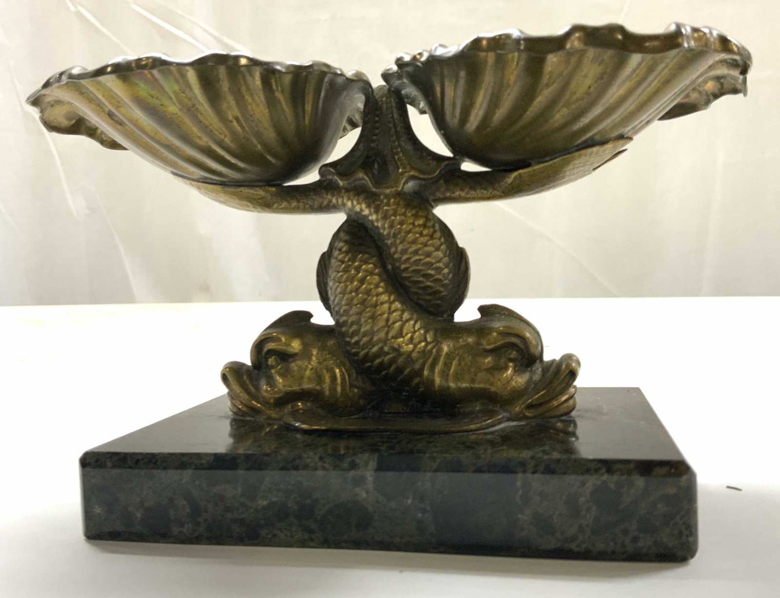 Antq Brass Dolphin Shell Form Calling Card Dish: 19th century brass vide Poche, or calling card dish ,features 2 stylized shell bowls supported by intertwined fish The entire figural sculpture is mounted on a rectangular black marble plinth. App 4