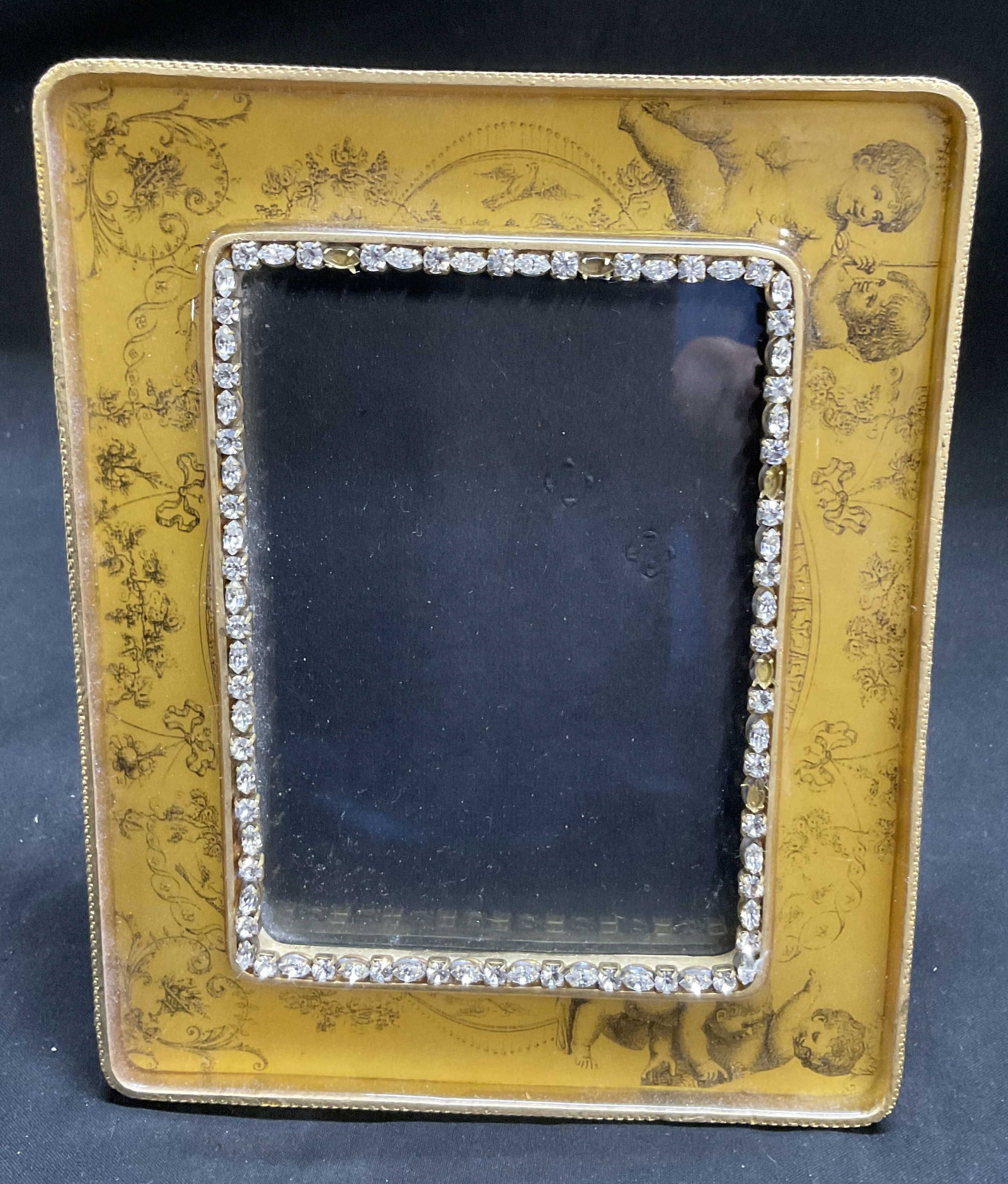 VTG John Wind Maximal Art Cherubs Picture Frame: Vintage John Wind Original Maximal Art Design Rectangular Picture Frame. Cherubs and Classical Motifs Graphics Yellow Enamel. Gilt Metal Trim. Rhinestone Encrusted Border. Missing Stones. Measures app