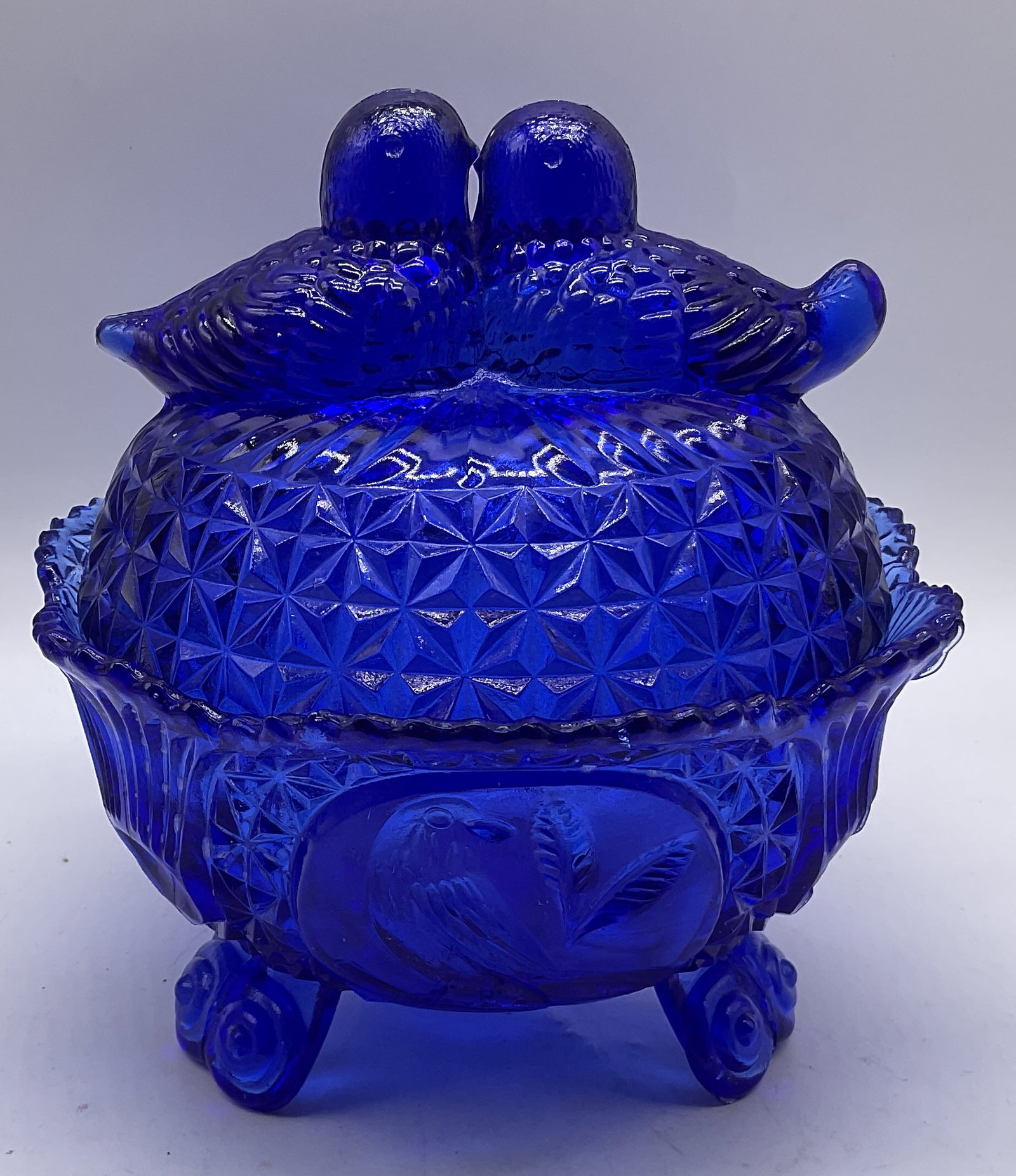 VTG Hofbauer Cobalt Blue Byrds Glass Candy Dish: VTG Hofbauer Cobalt Blue Byrds Collection Glass Candy Dish. No visible markings. Features two 3D lovebirds on lid and Bird etchings along side. 3-Footed. Condition consistent with exposure. Measures a