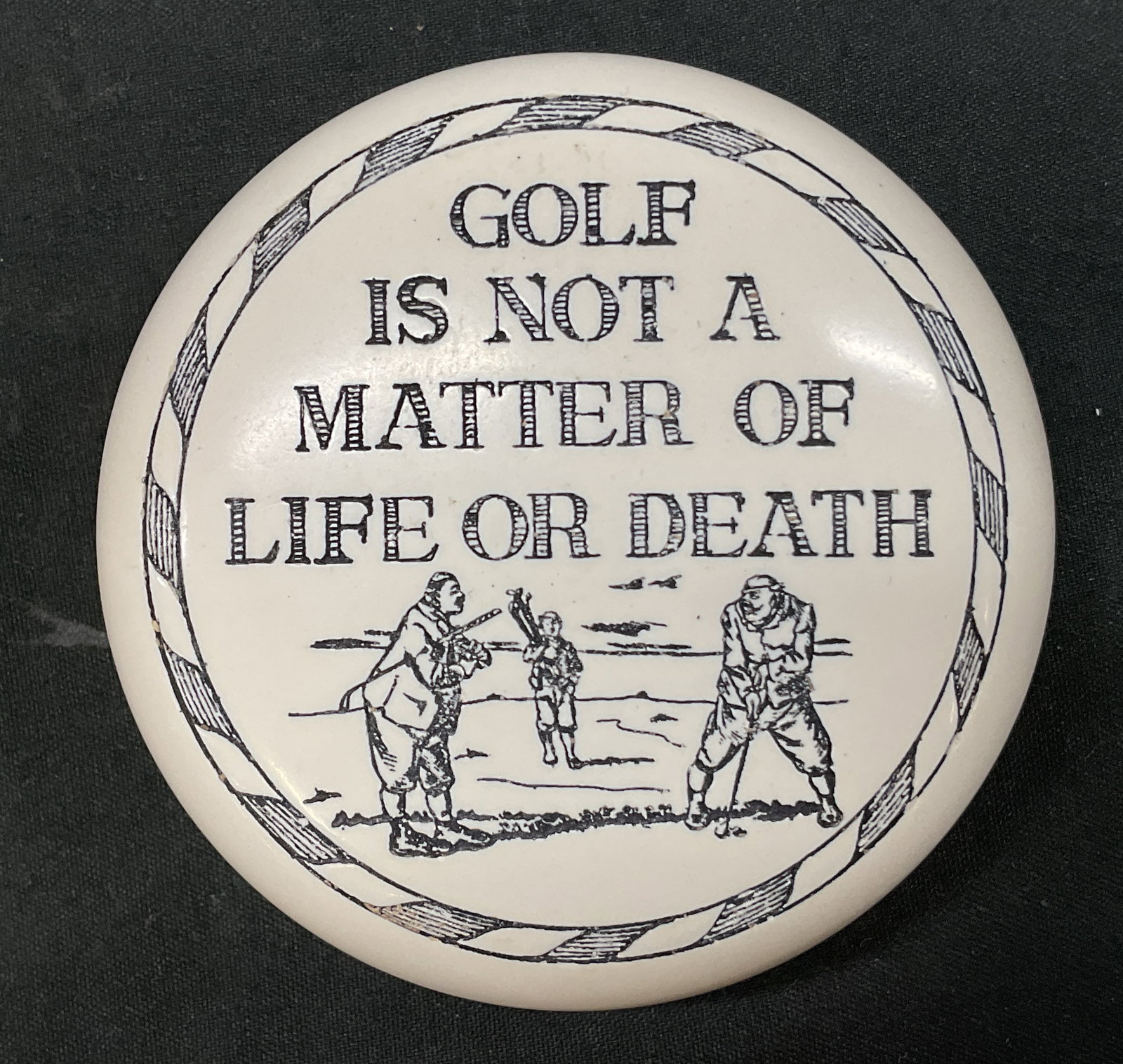 Vtg. Baekgaard Golf paperweight, United Kingdom: Vtg. Baekgaard Golf paperweight, made United Kingdom/England. Approx measurement 2.5 in across x 1 in tall. Top reads Golf is not a matter of life and death. Side reads it is much more important than 