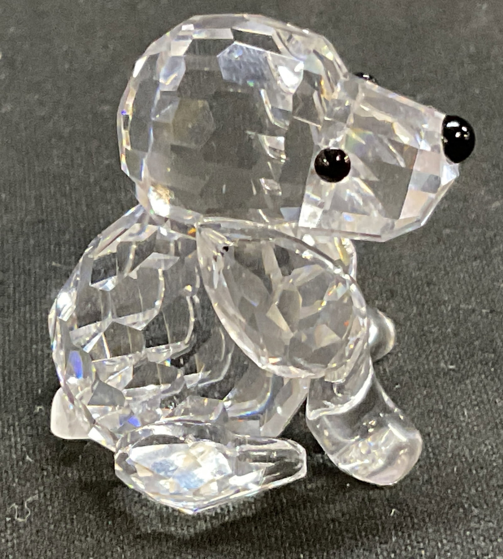 VTG Swarovski Crystal Sitting Dog Figurine: Vintage Circa 1990-2010s Swarovski Crystal Sitting Dog Figurine. Crystal Ball Head and Body. Bead Eyes and Nose. Chip Present. Measures app 1.25in H x 1in L. Vintage Figurines, Swarovski Crystal, Dogs