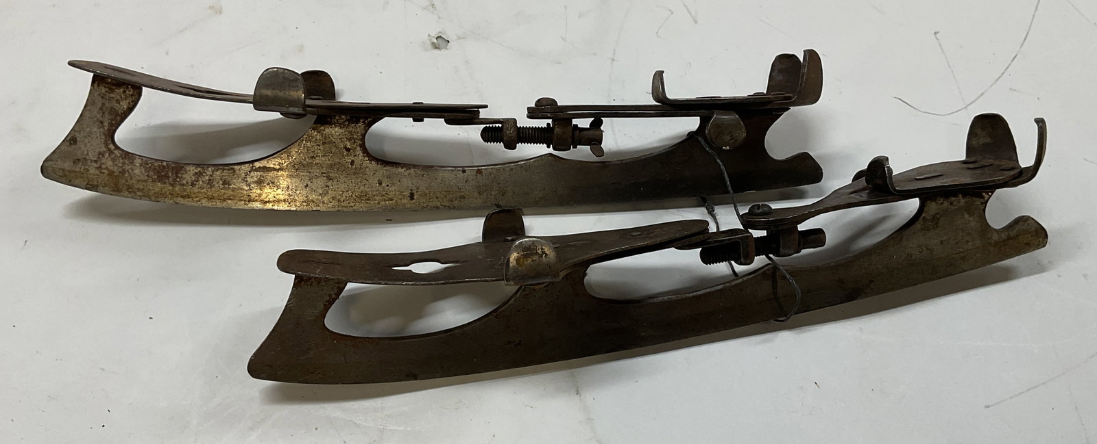 Antq Clamp On Ice Skates: Antique clamp on ice skates. From the late 1800s these are designed to attach directly to the sole of a leather boot. They feature metal toe and heel clamps alongside the threaded adjustment mechanism