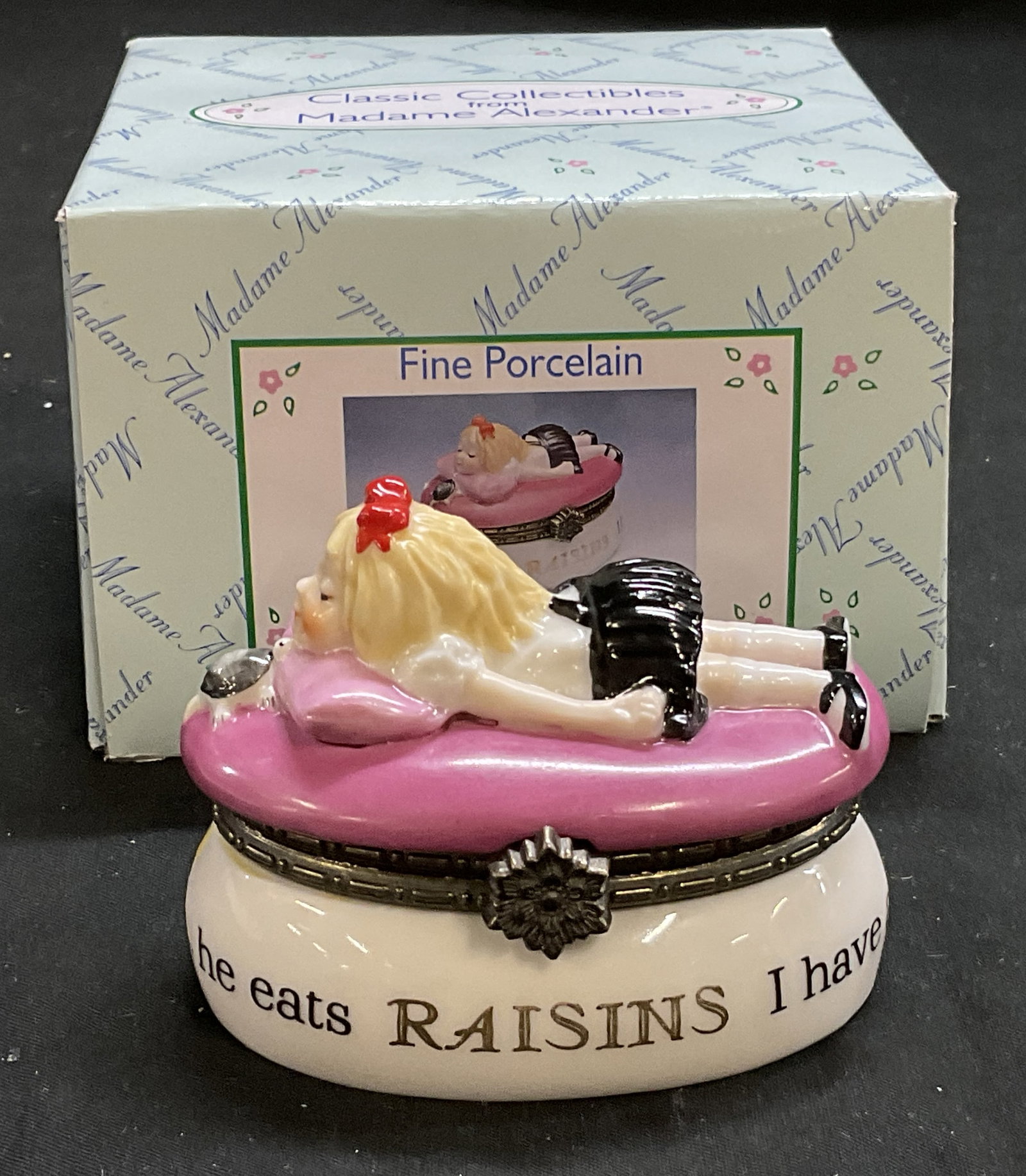 99 Madame Alexander Eloise Porcelain Trinket Box: Vintage 1999 Madame Alexander Eloise Fine Porcelain Trinket Box. Made Exclusively for F.A.O. Schwarz. Depicts Eloise Character Laying with Her Pet Turtle on A Bright Pink Bed. Wrap-Around Text Reads