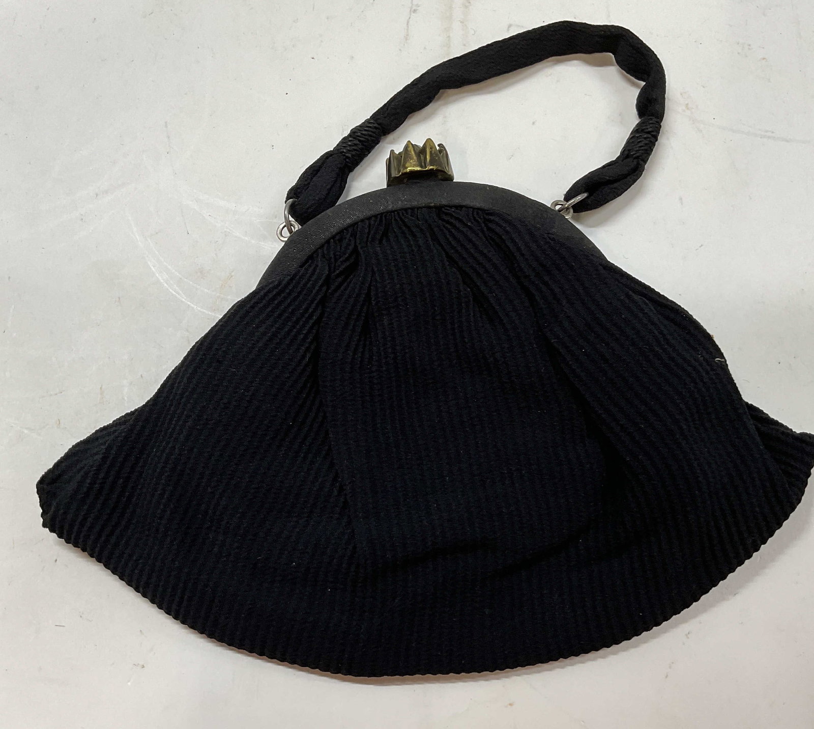 Antq Cotton Ribbed Bag W Jewel Clasp: Antique cotton ribbed bag. Black bad with a jeweled clip in closure. Inside features a smaller pocket for organization and smaller items. Wear from use and age. App 7 in height app 9 in length app 3 i
