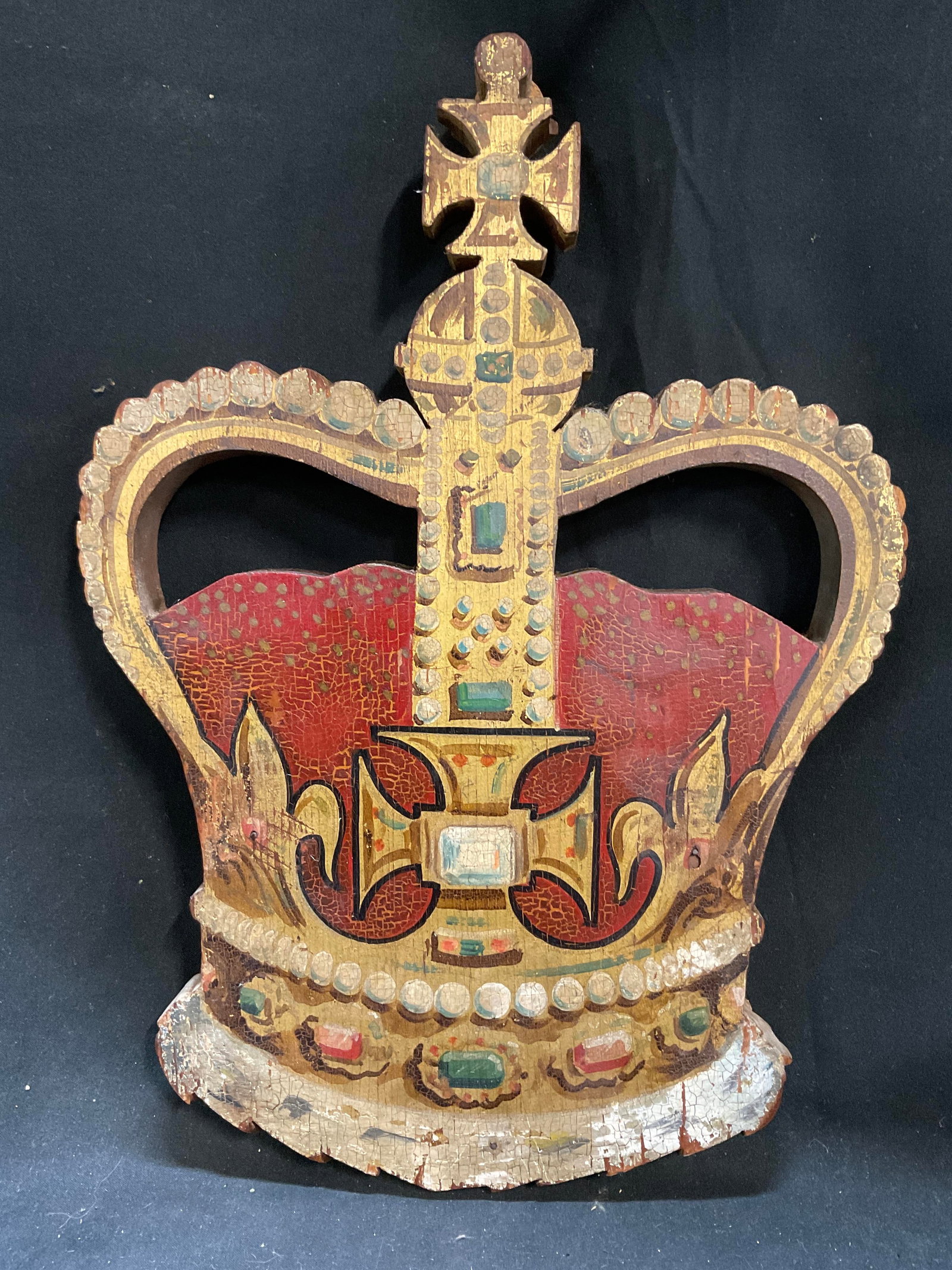 ANTQ Carved Wooden British Sty Royal Crown Plaque: Antique Carved Wooden British Heraldry Style Royal Crown Plaque. Painted Red Velvet Cap, Gilt Frame, and Jewels. Cross Finial. Pins Covered by Corks at Back. Cracking and Paint Loss Present. Measures 