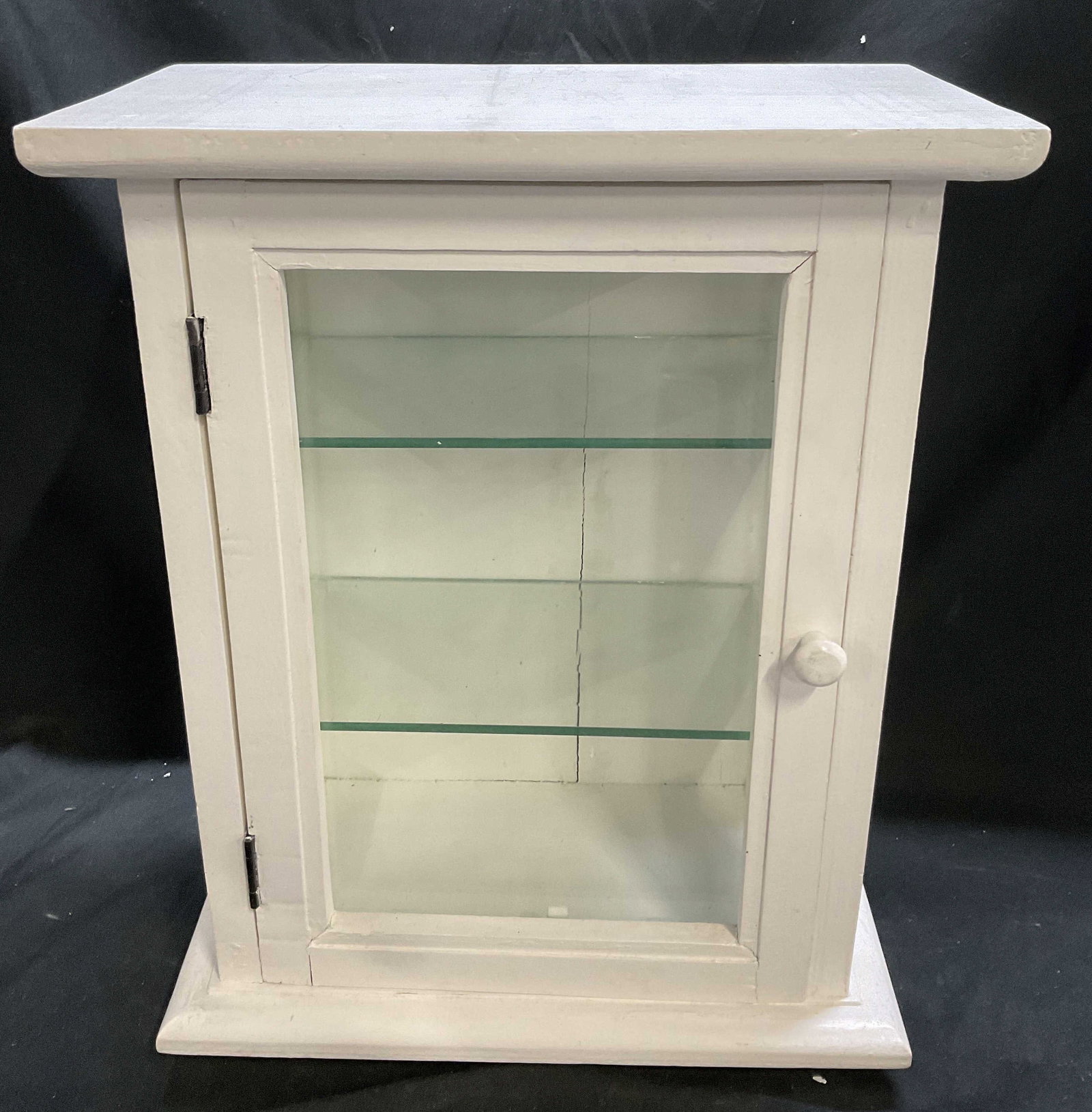 VTG Pottery Barn White Wall-Mount Cabinet: Vintage Circa Early 2000s Pottery Barn Painted White Wooden Wall-Mount Cabinet. 2 Glass Shelves Inside. Hinged Door. Measures app 17.75in H x 13.75in L x 7.5in W. Cracks in Wood. Chips in Glass. Vinta