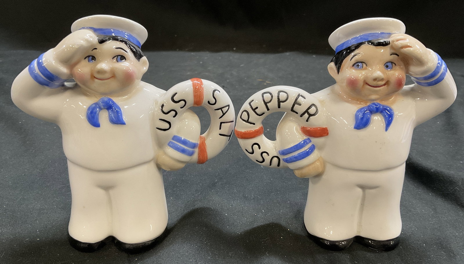 VTG Clay Art Sailor Boy Salt and Pepper Shakers: Vintage Circa 1970s-2000s Clay Art Sailor Boy Ceramic Salt and Pepper Shakers. Two Rosy-Cheeked Sailor Figures in White Uniforms Holding Lifebuoy Rings. One Reads USS Salt and Other Reads USS Pepper. 