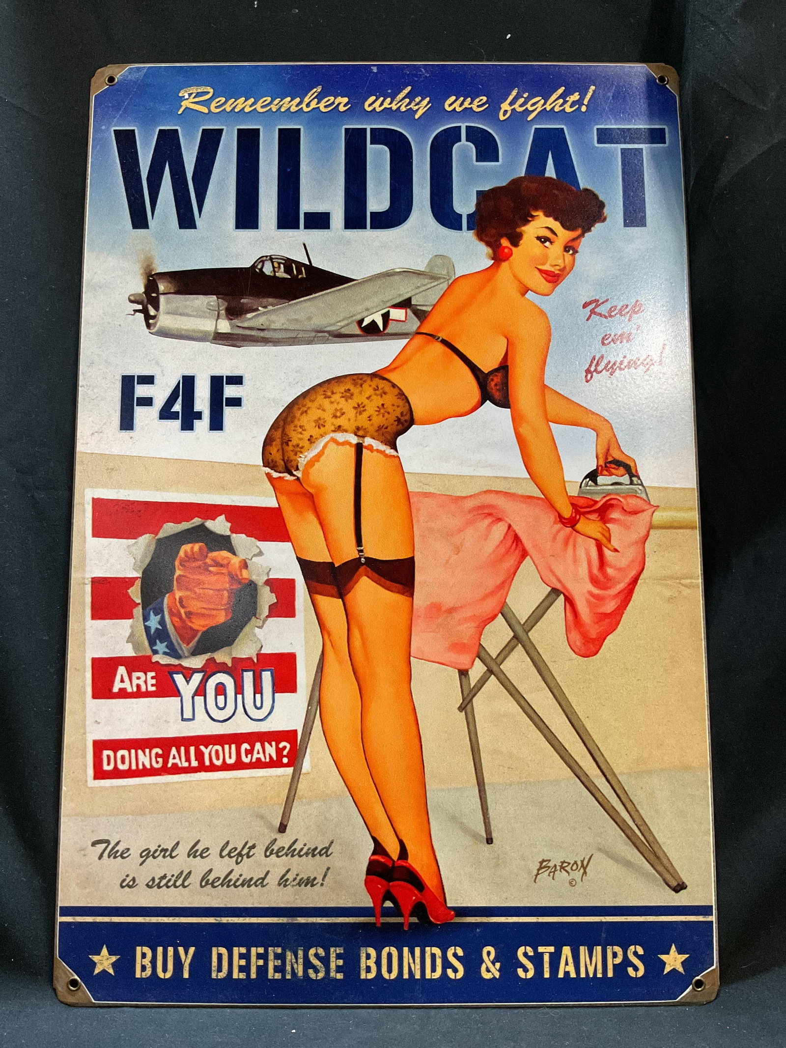 Vtg Style Wildcat Metal Sign: Vintage style metal sign featuring a pin-up girl and a Grumman aircraft. Surface wear consistent to age, use & exposure. No visible signature or makings. Measurements: length 17.5in x width 11.5in. Vi