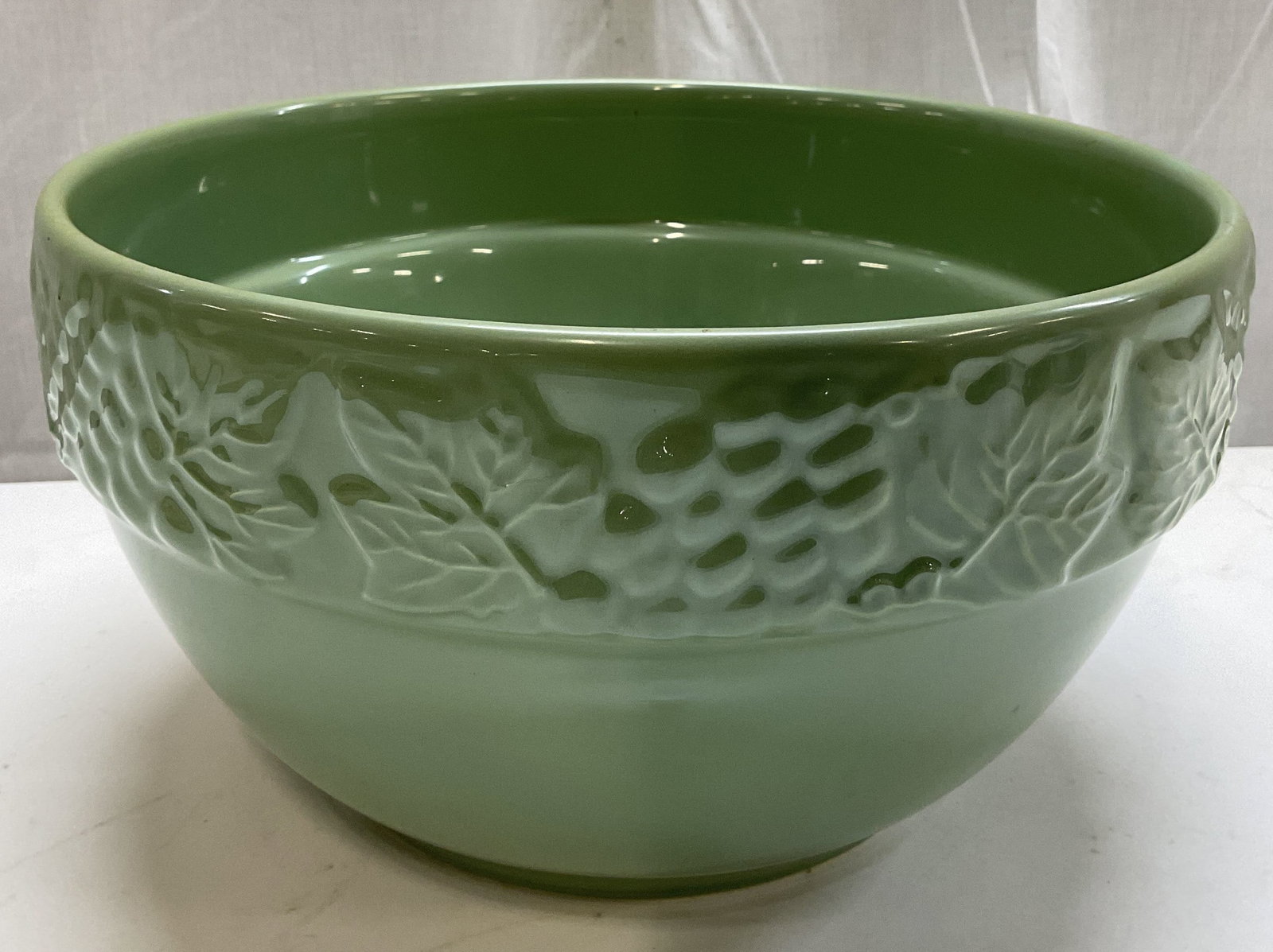 Embossed Grape Vine Ceramic Bowl PORTUGAL: Ceramic bowl featuring an embossed grape vine pattern. Mint green toned. Signed & marked on underside. Reads, Made in Portugal. Surface wear consistent to age, use & exposure. Measurements: length