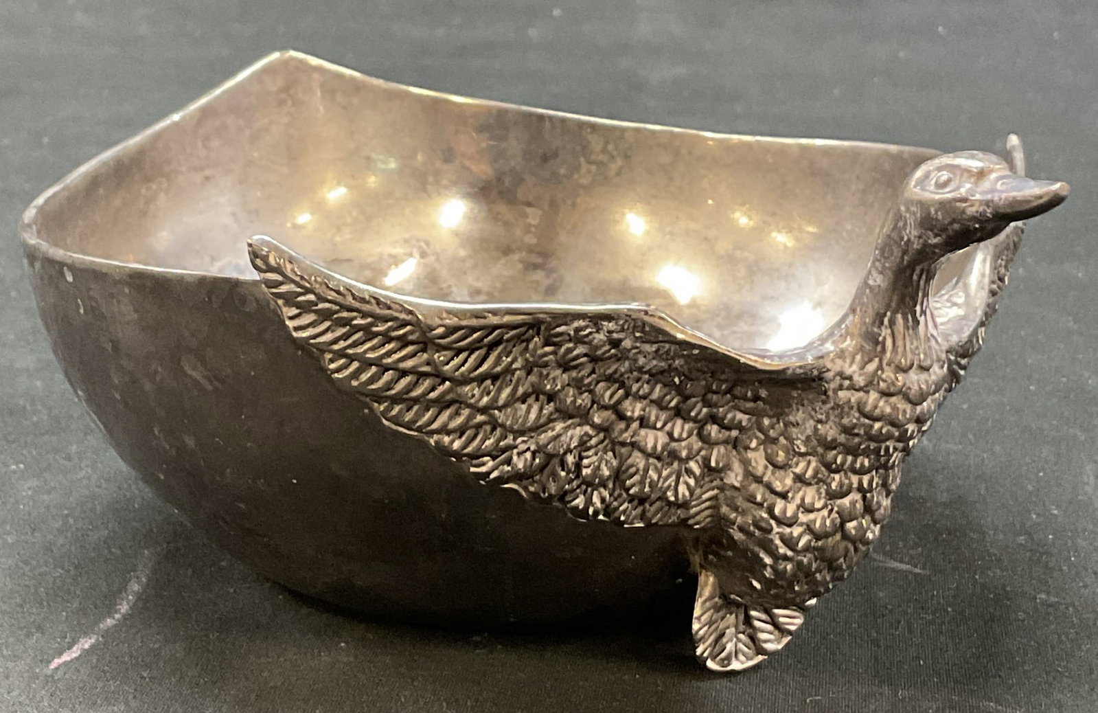 Silea Silver Plated Duck Bowl: Silea silver plated duck bowl. Marked on underside. Round shape with arched back. Duck figure with its wings spread. Detailed features. Measures ht approx 3 inches diam approx 5 inches. Scratching.