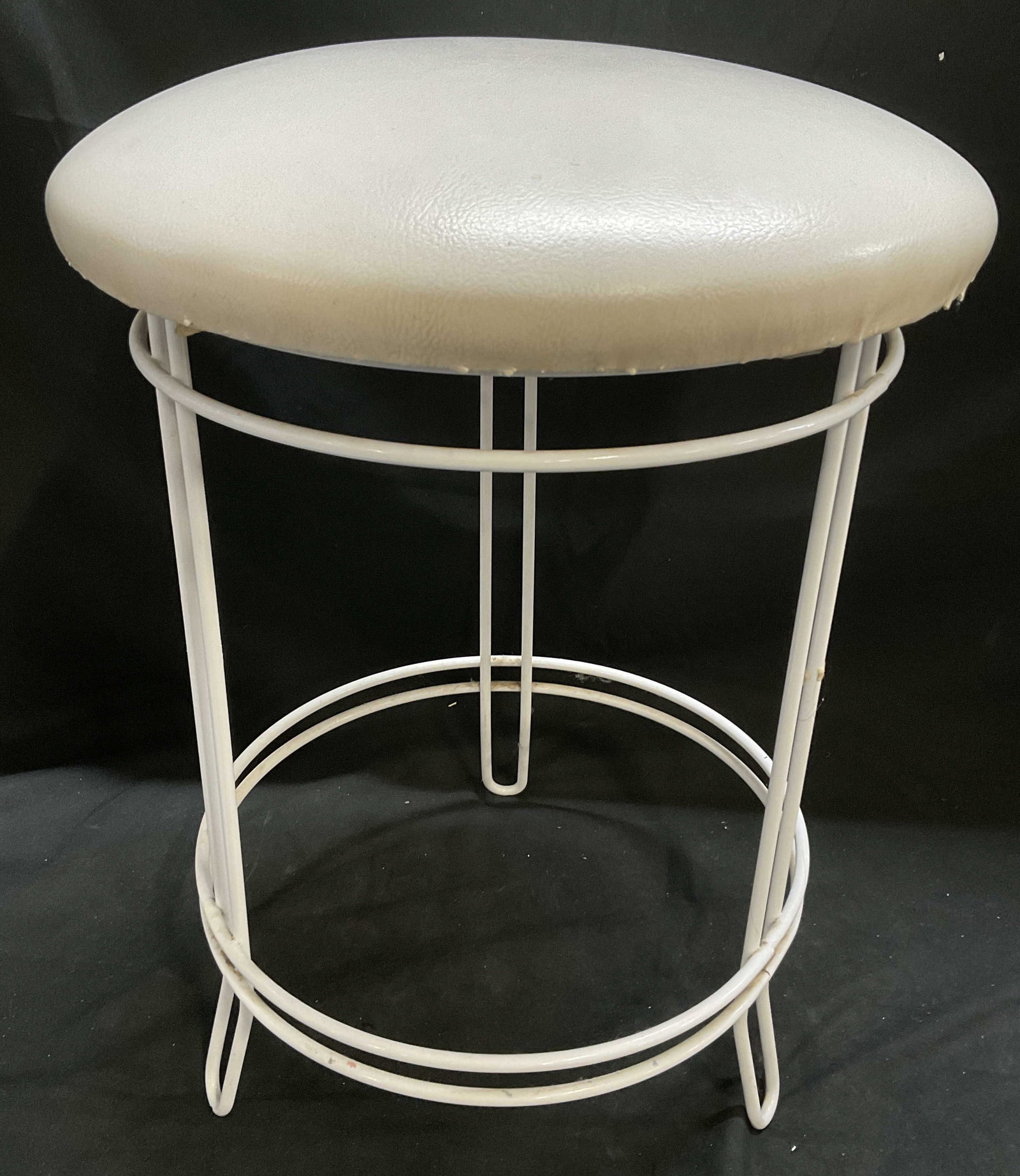 Mid-Century Modern White Cushioned Iron Stool: Mid-Century Modern Iron Stool. White Leather-Style Cushion. Originally Sold by Wythe Upholstery Co. Some Staining and Wear to Coating. Measures app 18.5in H x 12in Diam. MCM, Vintage, Iron, Stools, Wh