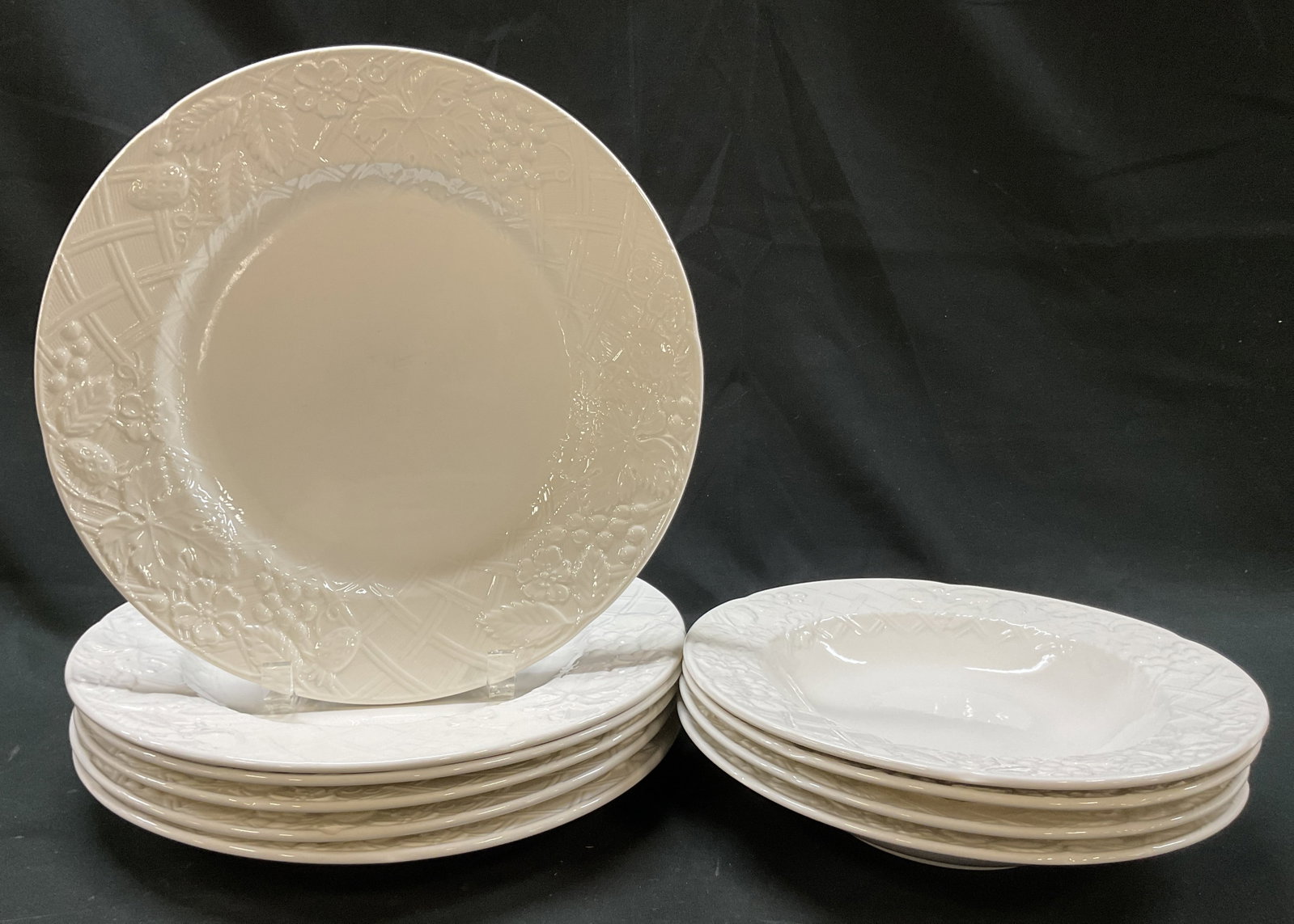 Set 10 Mikasa White English Countryside Tableware: 10 piece Mikasa White English Countryside ceramic tableware set. Includes 6 plates and 4 bowls. Marked on underside. Embossed fruit pattern with basketweave background. Measures approx 11 inches in