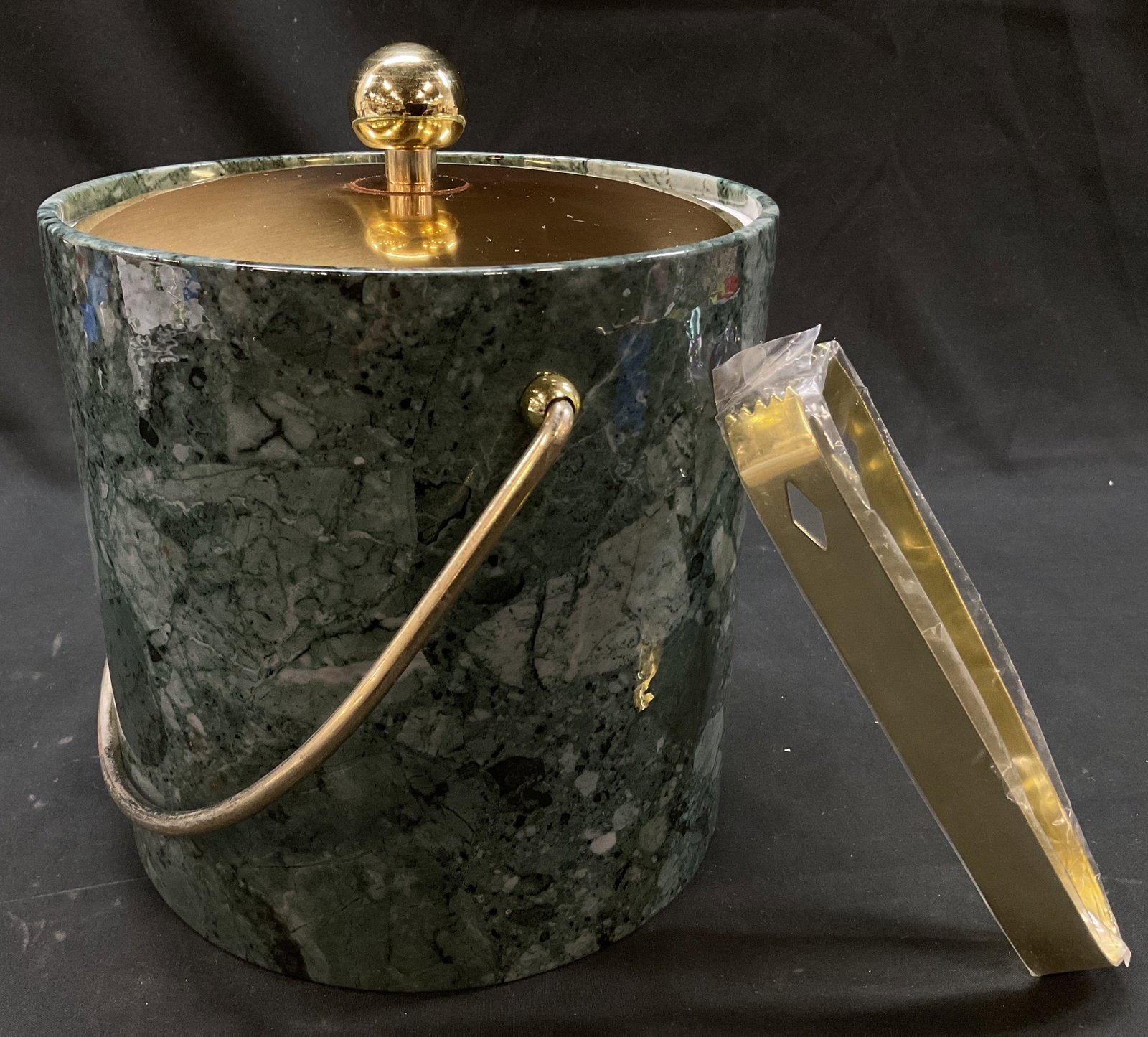 Vtg Kraftware Faux Gr. Marble Ice Bucket + Tongs: Vintage Kraftware Faux Green Marble Lidded Ice Bucket + Tongs.c.1970s insulated ice bucket set by Kraftware. Brass lid and tongs. Measures approx. with lid- 9.5in tall 7.5in dia. 3quart capacity Surfa