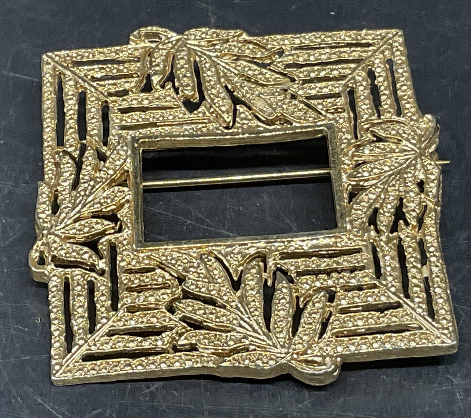 VTG Gold-Toned Botanical Leaf Frame Brooch: Vintage Gold-Toned Botanical Leaf Square Frame Brooch. Pierced Design. Condition Consistent With Exposure. Measures app 2in H x 2in W. Vintage Brooches, Gold-Toned, Leaves, Frames, Pins, Costume Jewel