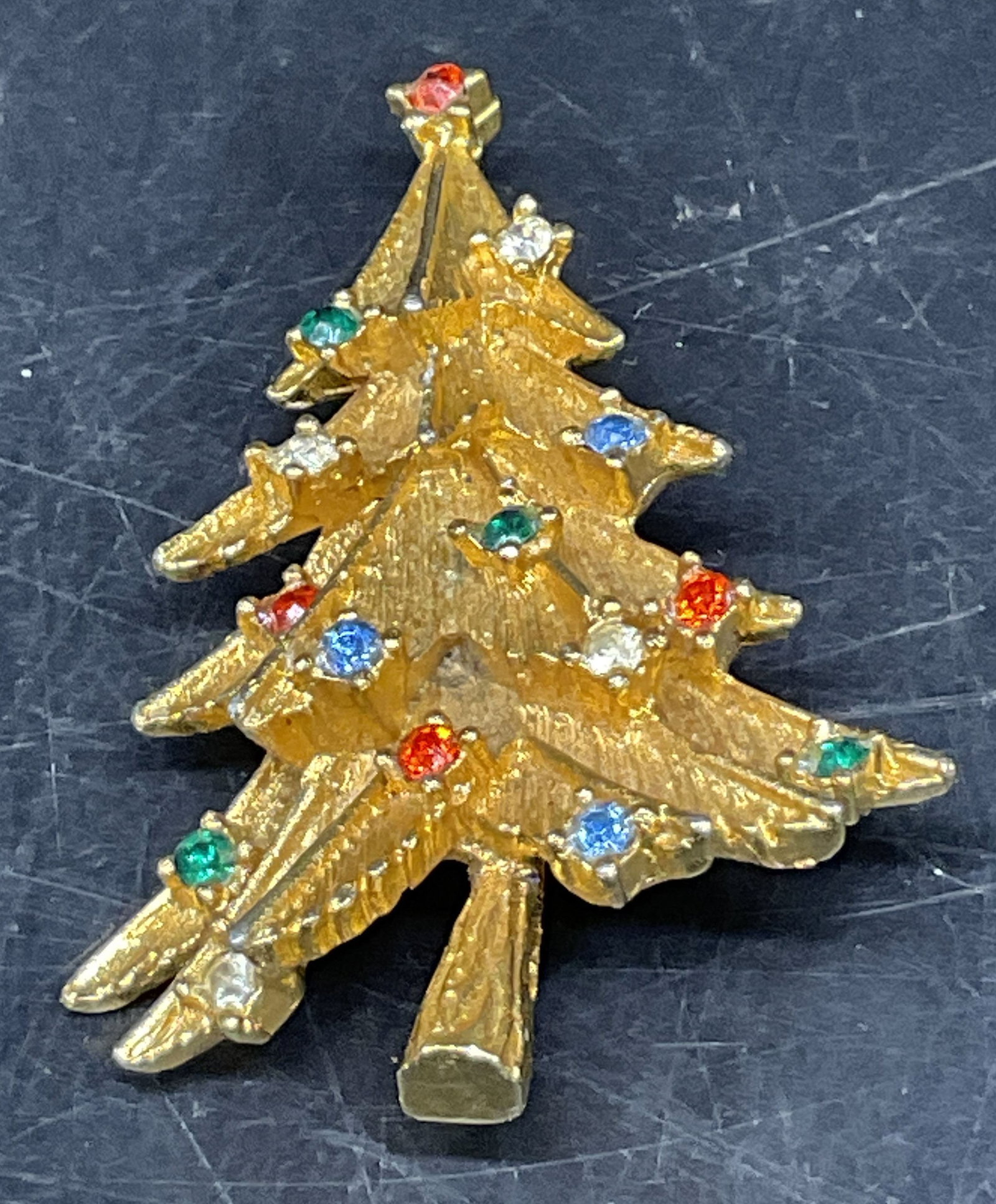 VINTAGE Gold-Toned Christmas Tree Brooch: Vintage Gold-Toned Textured Christmas Tree Brooch. Multicolored Rhinestone Ornament Accents. No Visible Markings or Brand. Condition Consistent With Exposure. Measures app 2in H x 1in W. Vintage